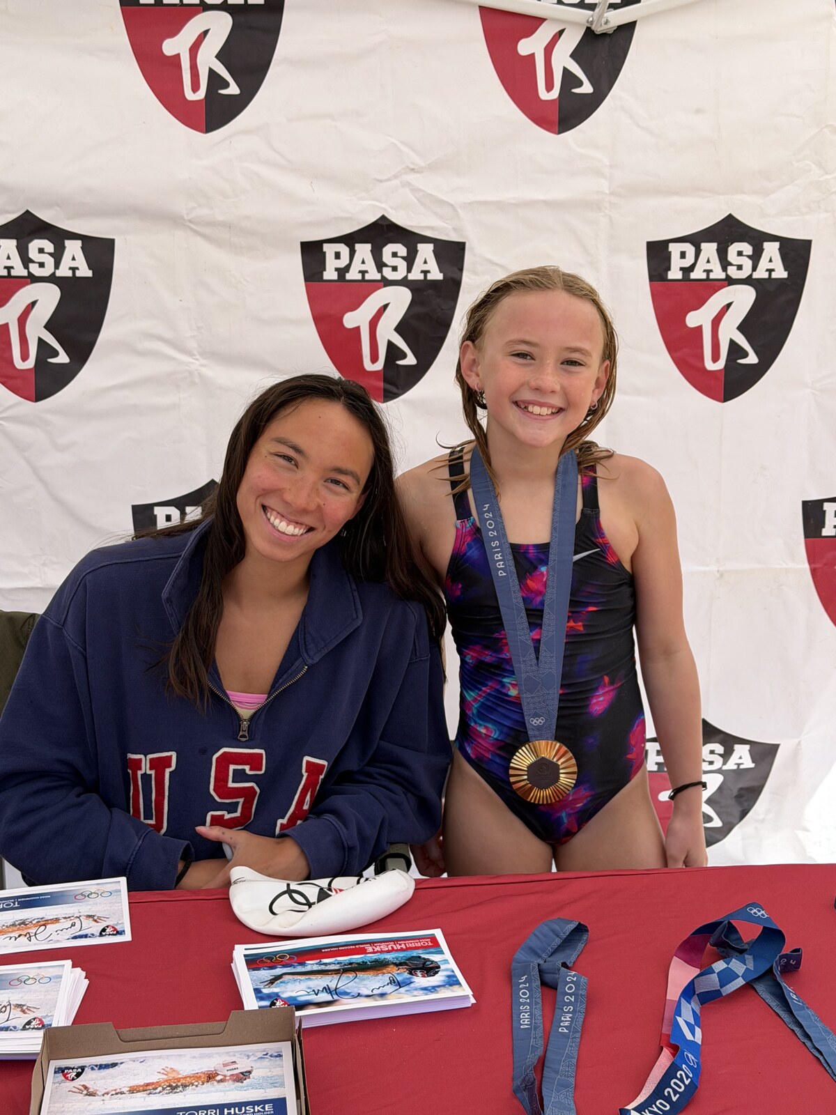 Olympic champion Torri Huske with PASA swimmers at PASA-Rinconada, signing autographs and posing with her Paris 2024 Olympic gold medal