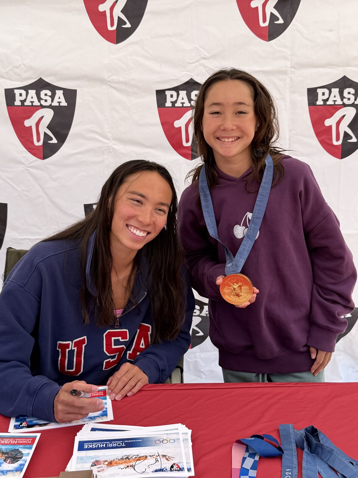 Olympic champion Torri Huske with PASA swimmers at PASA-Rinconada, signing autographs and posing with her Paris 2024 Olympic gold medal