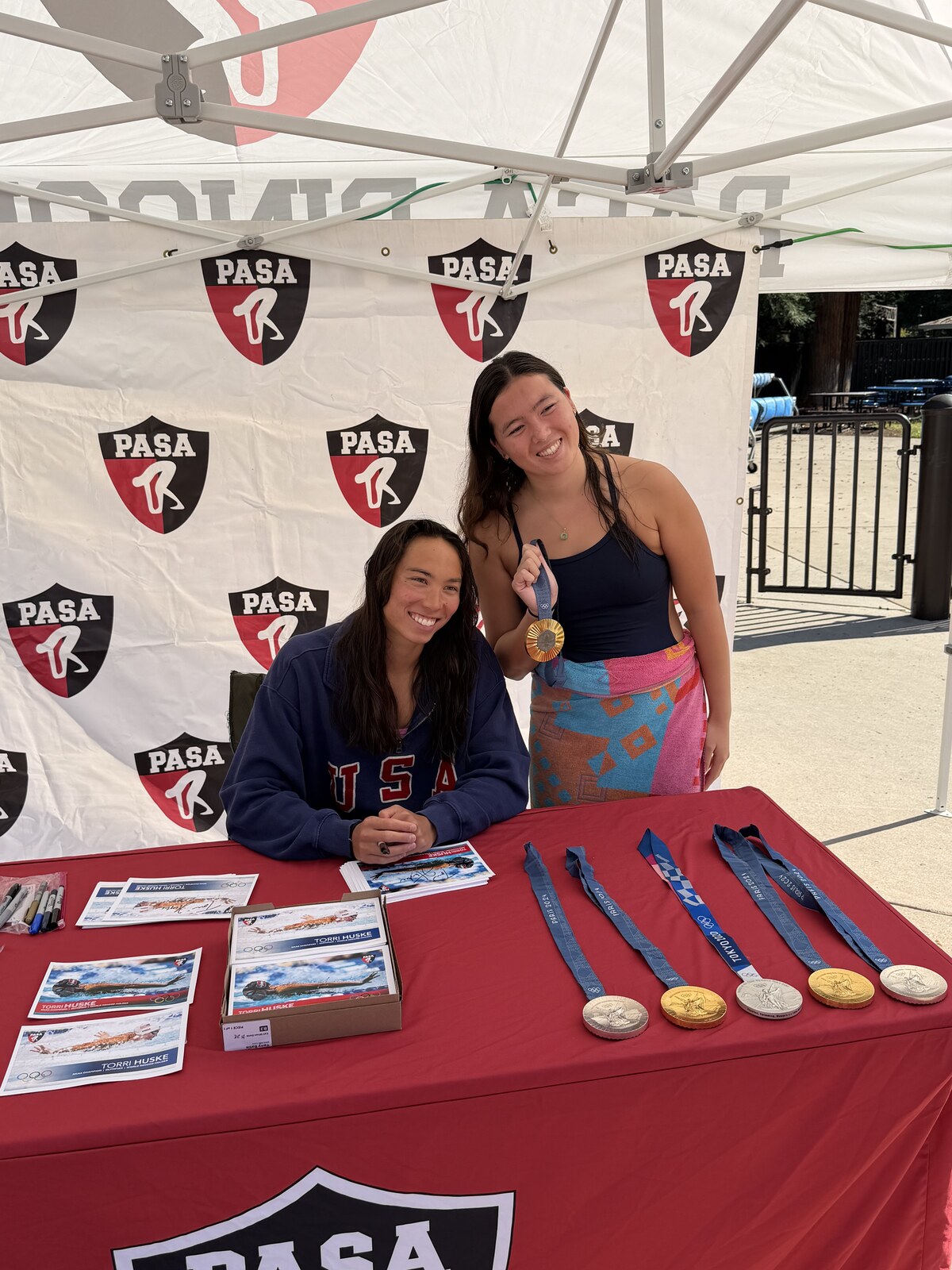 Olympic champion Torri Huske with PASA swimmers at PASA-Rinconada, signing autographs and posing with her Paris 2024 Olympic gold medal