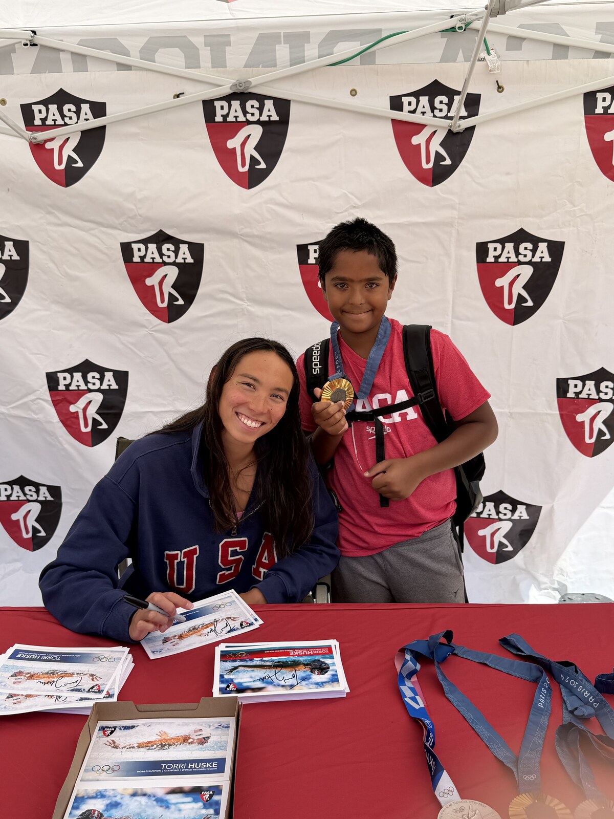 Olympic champion Torri Huske with PASA swimmers at PASA-Rinconada, signing autographs and posing with her Paris 2024 Olympic gold medal