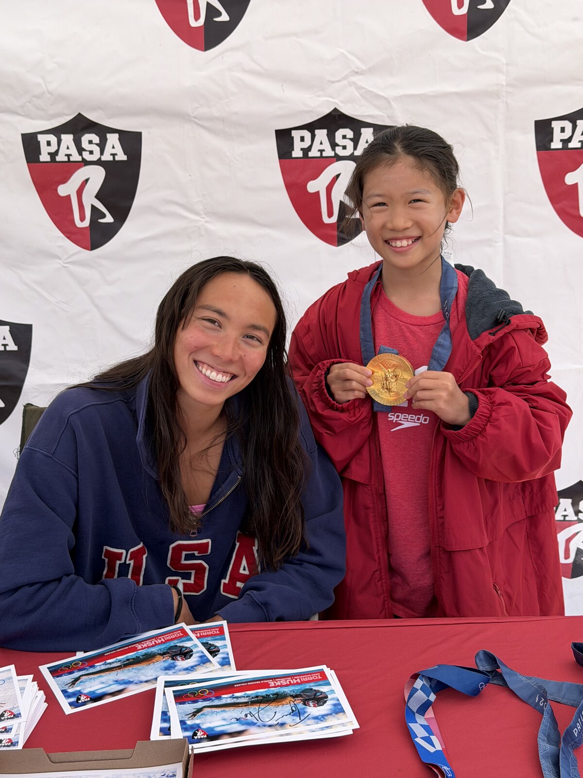 Olympic champion Torri Huske with PASA swimmers at PASA-Rinconada, signing autographs and posing with her Paris 2024 Olympic gold medal