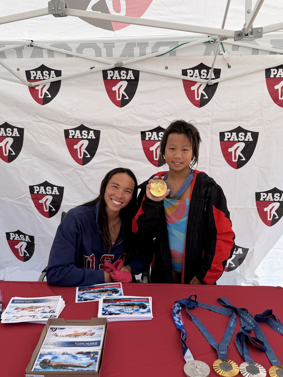 Olympic champion Torri Huske with PASA swimmers at PASA-Rinconada, signing autographs and posing with her Paris 2024 Olympic gold medal