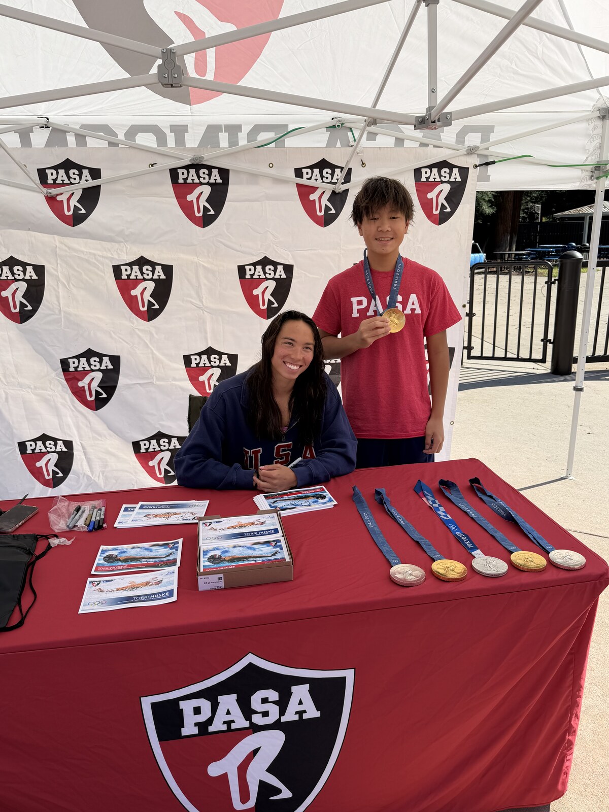 Olympic champion Torri Huske with PASA swimmers at PASA-Rinconada, signing autographs and posing with her Paris 2024 Olympic gold medal