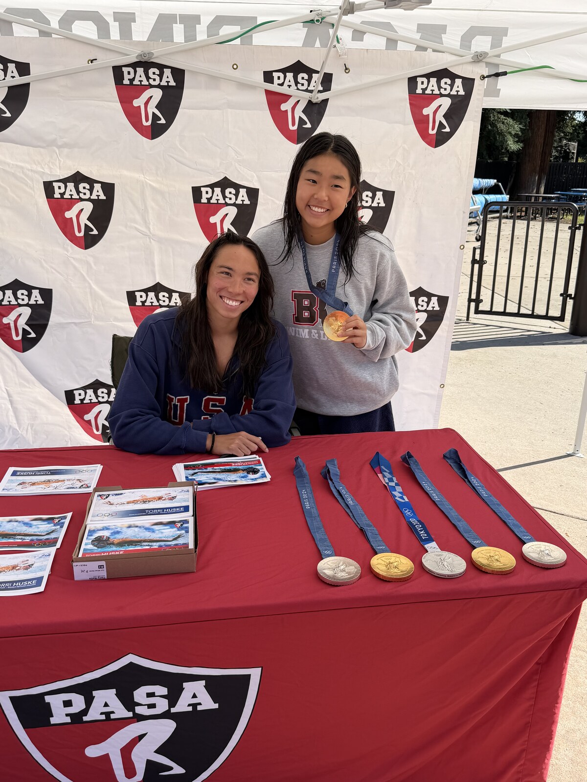 Olympic champion Torri Huske with PASA swimmers at PASA-Rinconada, signing autographs and posing with her Paris 2024 Olympic gold medal
