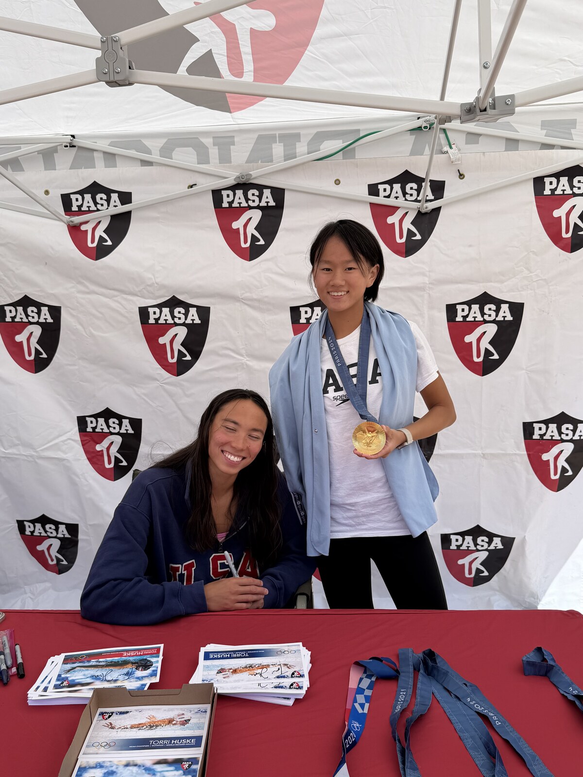 Olympic champion Torri Huske with PASA swimmers at PASA-Rinconada, signing autographs and posing with her Paris 2024 Olympic gold medal