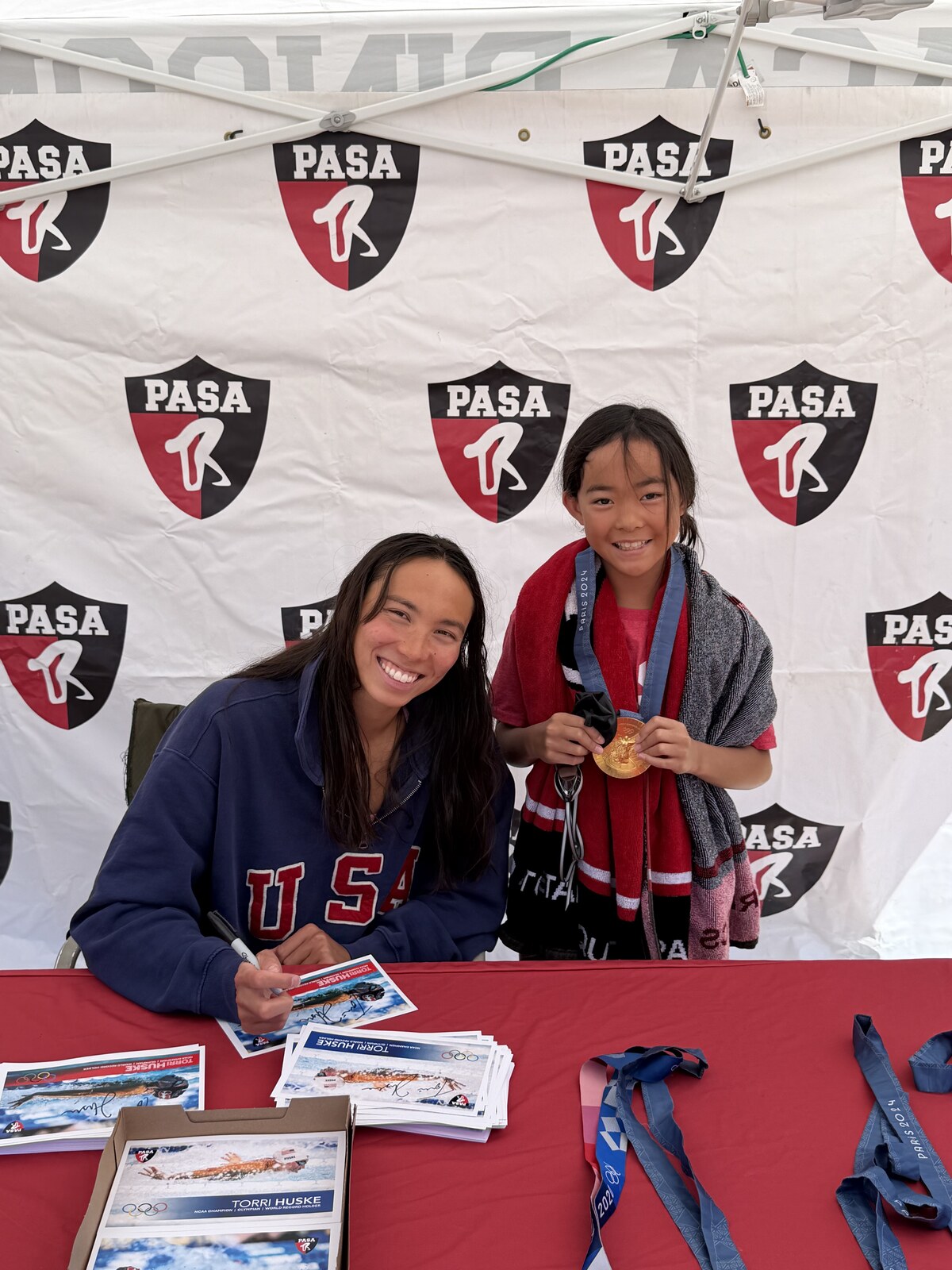 Olympic champion Torri Huske with PASA swimmers at PASA-Rinconada, signing autographs and posing with her Paris 2024 Olympic gold medal