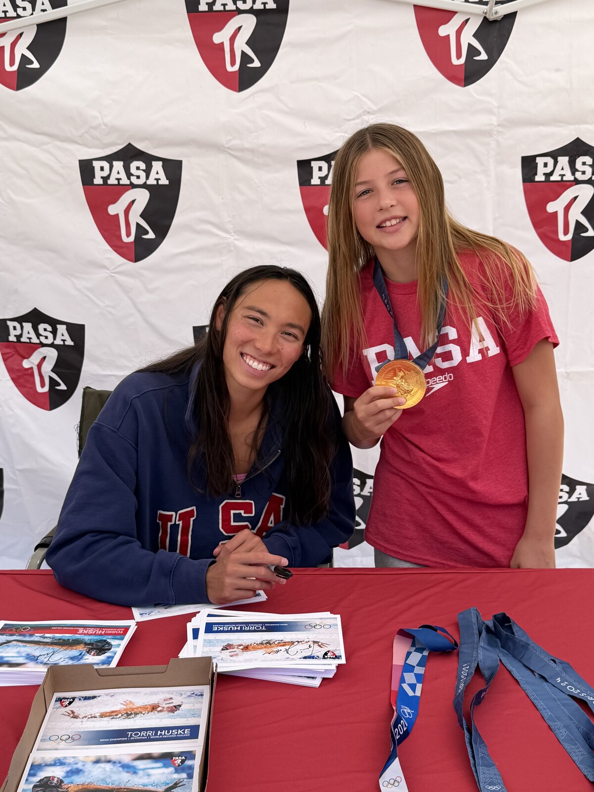 Olympic champion Torri Huske with PASA swimmers at PASA-Rinconada, signing autographs and posing with her Paris 2024 Olympic gold medal