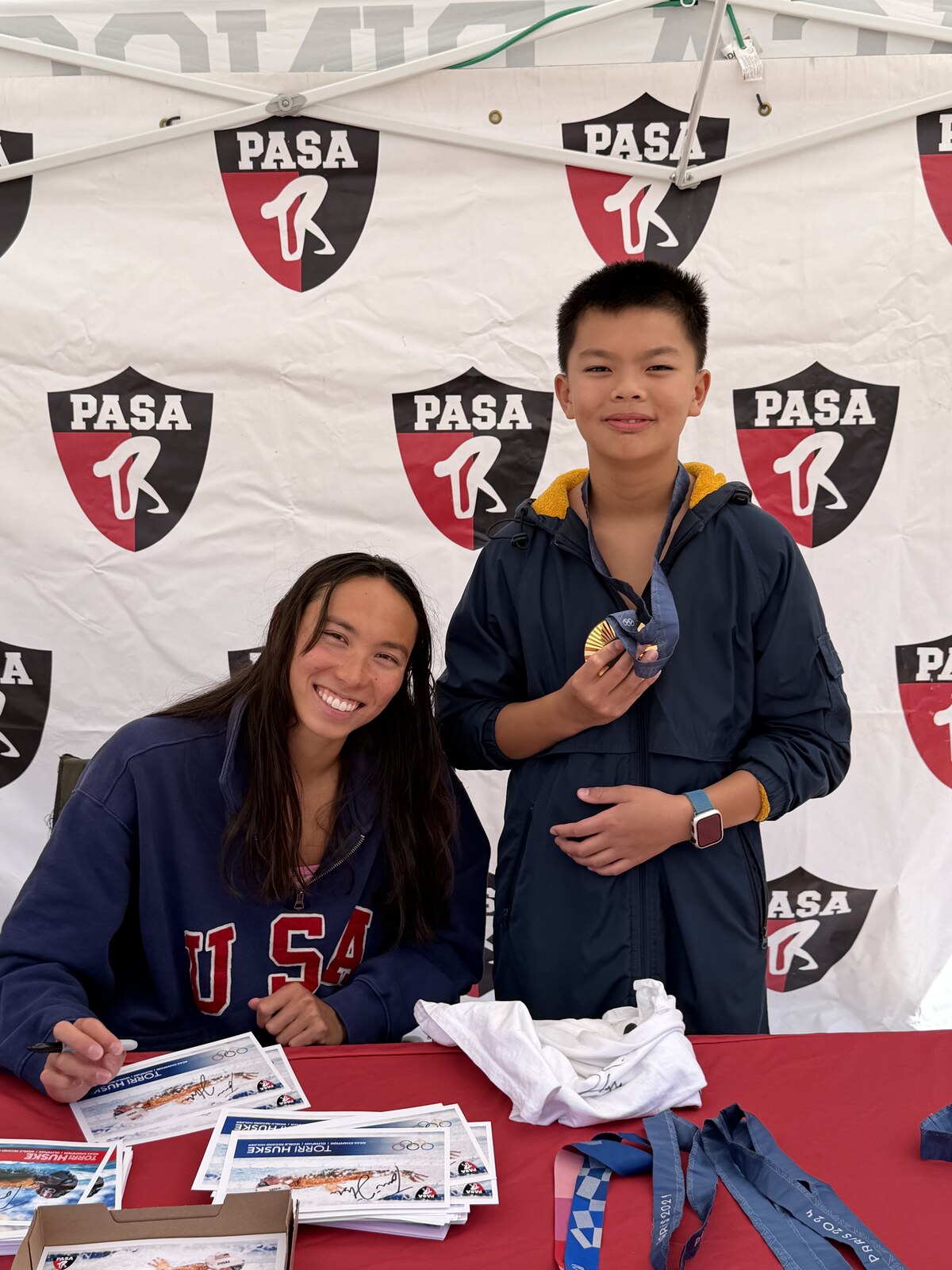 Olympic champion Torri Huske with PASA swimmers at PASA-Rinconada, signing autographs and posing with her Paris 2024 Olympic gold medal