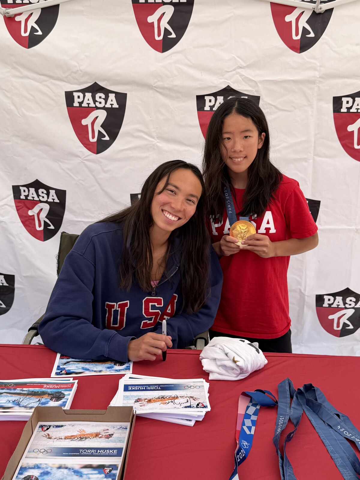 Olympic champion Torri Huske with PASA swimmers at PASA-Rinconada, signing autographs and posing with her Paris 2024 Olympic gold medal