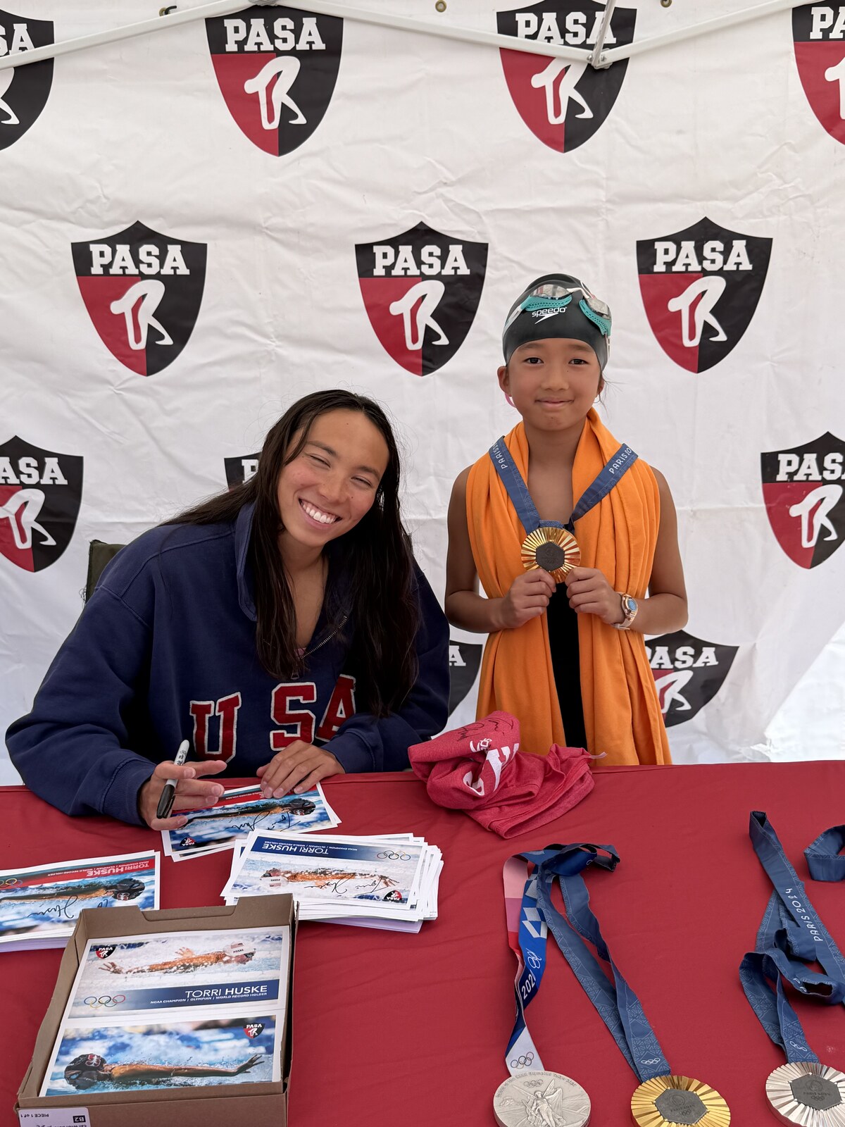 Olympic champion Torri Huske with PASA swimmers at PASA-Rinconada, signing autographs and posing with her Paris 2024 Olympic gold medal