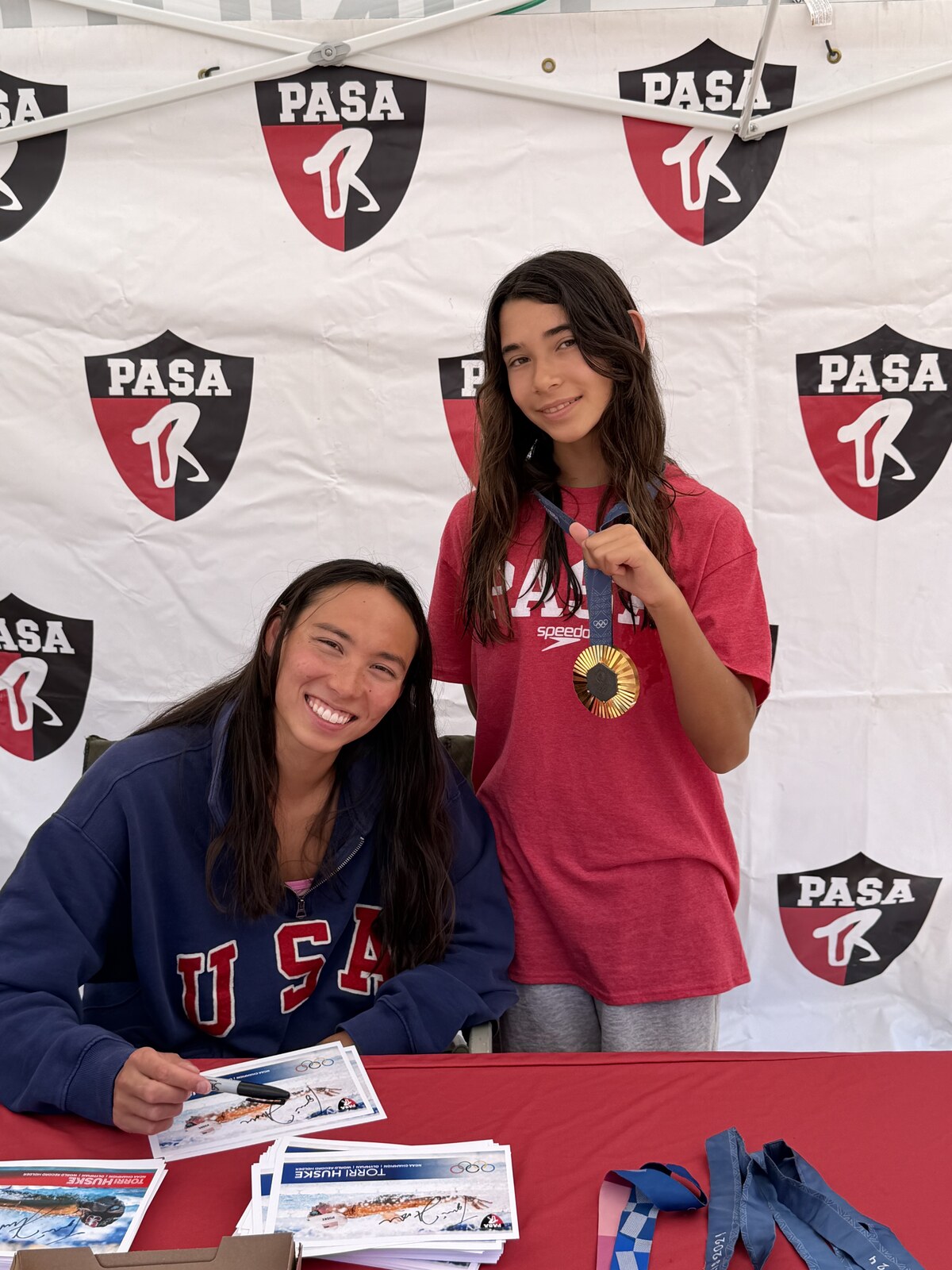 Olympic champion Torri Huske with PASA swimmers at PASA-Rinconada, signing autographs and posing with her Paris 2024 Olympic gold medal
