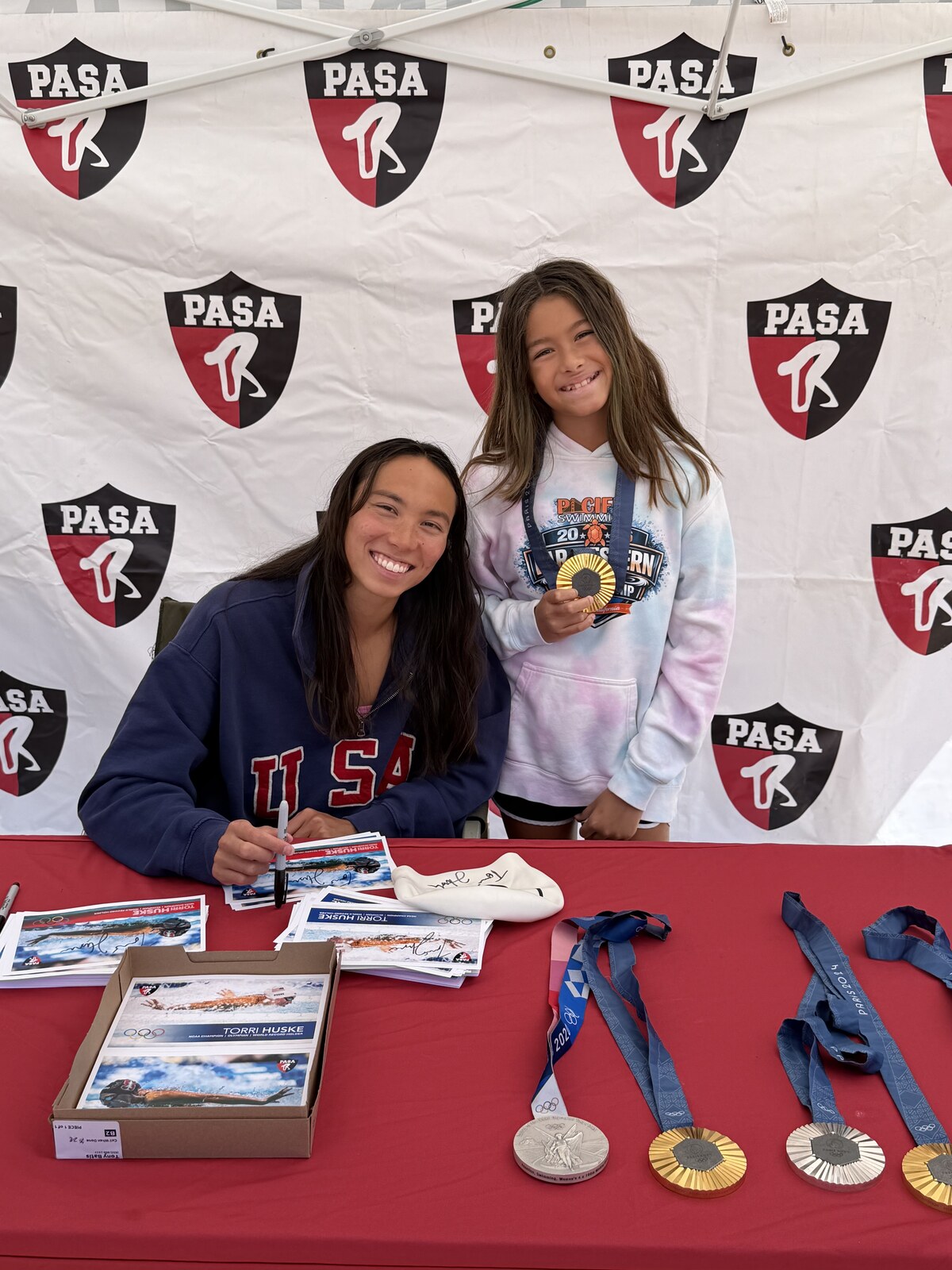Olympic champion Torri Huske with PASA swimmers at PASA-Rinconada, signing autographs and posing with her Paris 2024 Olympic gold medal