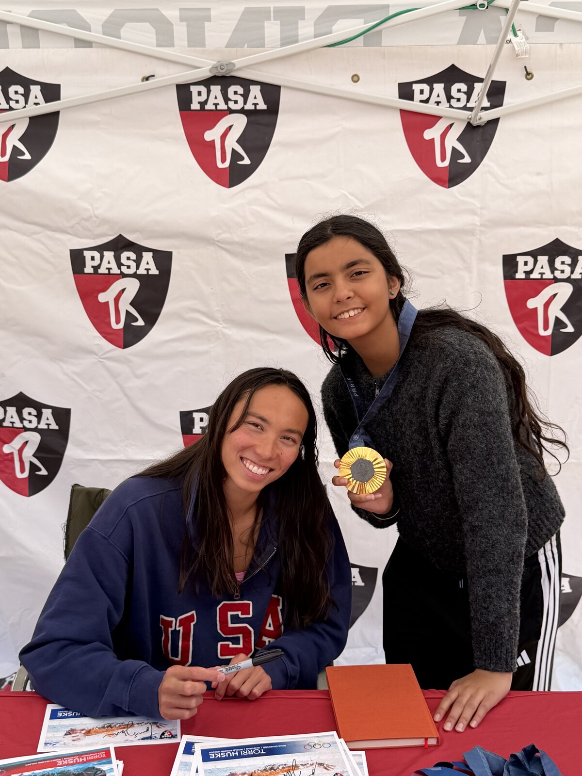 Olympic champion Torri Huske with PASA swimmers at PASA-Rinconada, signing autographs and posing with her Paris 2024 Olympic gold medal