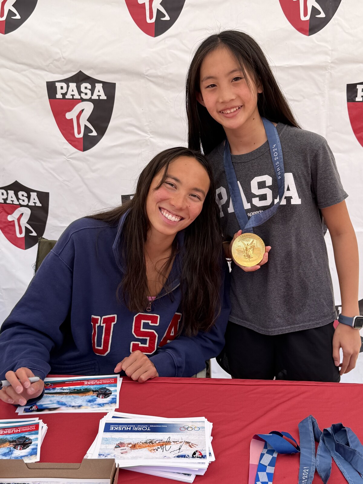 Olympic champion Torri Huske with PASA swimmers at PASA-Rinconada, signing autographs and posing with her Paris 2024 Olympic gold medal