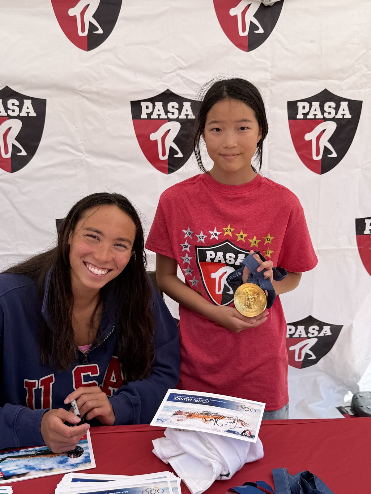 Olympic champion Torri Huske with PASA swimmers at PASA-Rinconada, signing autographs and posing with her Paris 2024 Olympic gold medal
