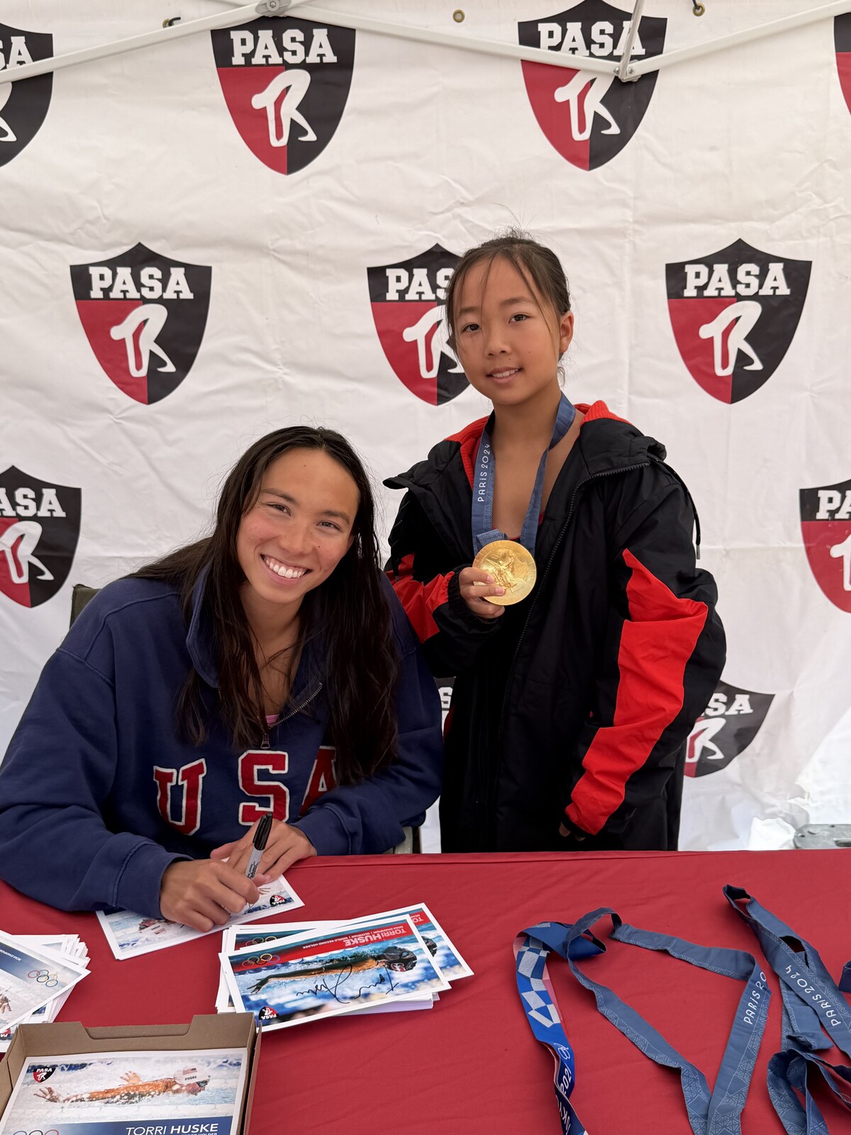 Olympic champion Torri Huske with PASA swimmers at PASA-Rinconada, signing autographs and posing with her Paris 2024 Olympic gold medal
