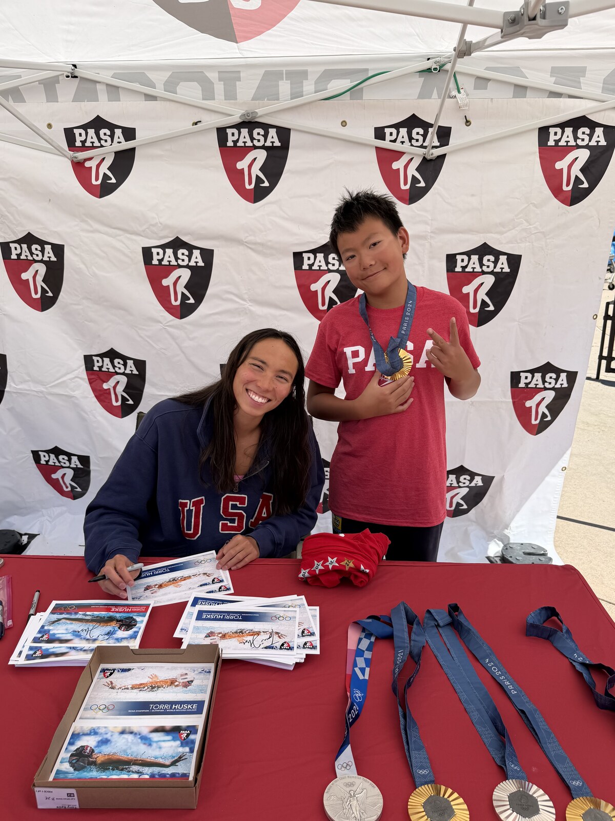 Olympic champion Torri Huske with PASA swimmers at PASA-Rinconada, signing autographs and posing with her Paris 2024 Olympic gold medal