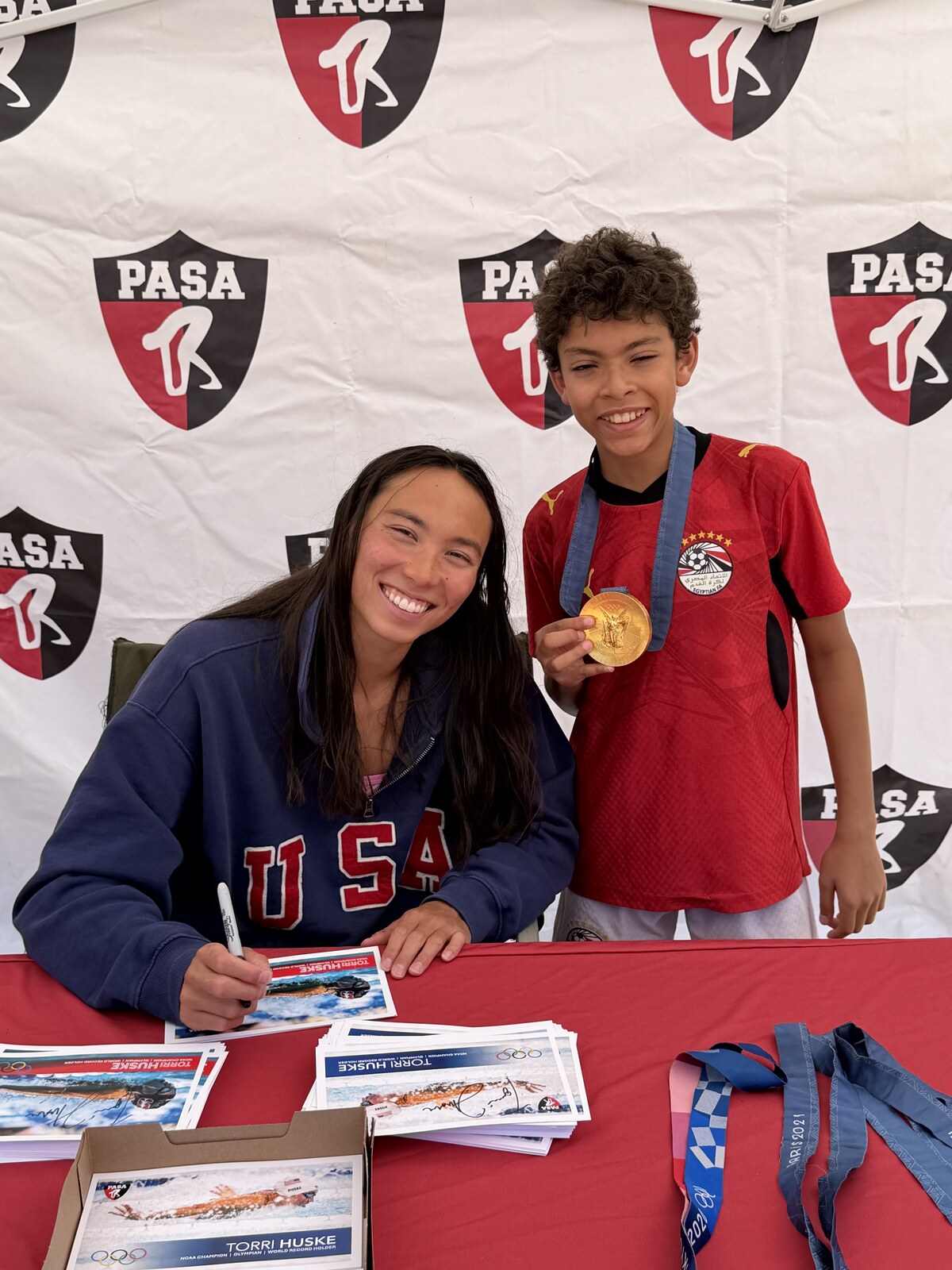 Olympic champion Torri Huske with PASA swimmers at PASA-Rinconada, signing autographs and posing with her Paris 2024 Olympic gold medal