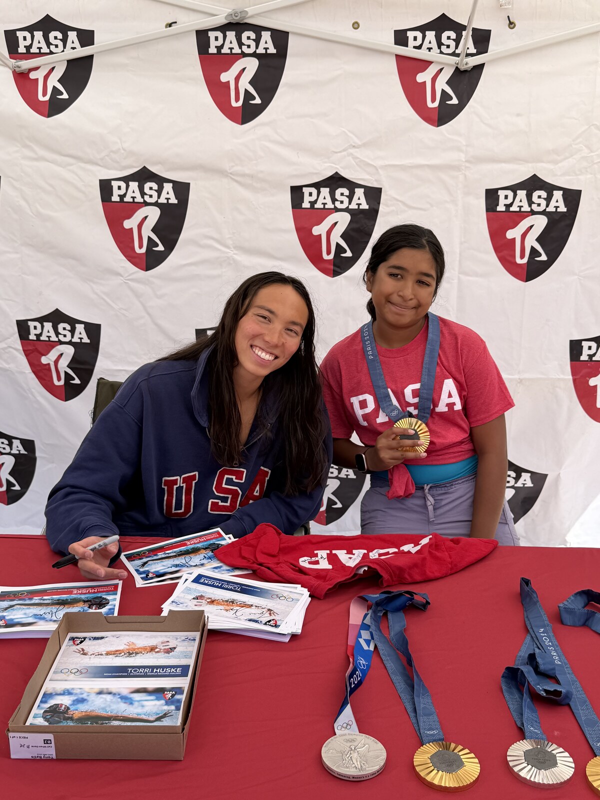 Olympic champion Torri Huske with PASA swimmers at PASA-Rinconada, signing autographs and posing with her Paris 2024 Olympic gold medal