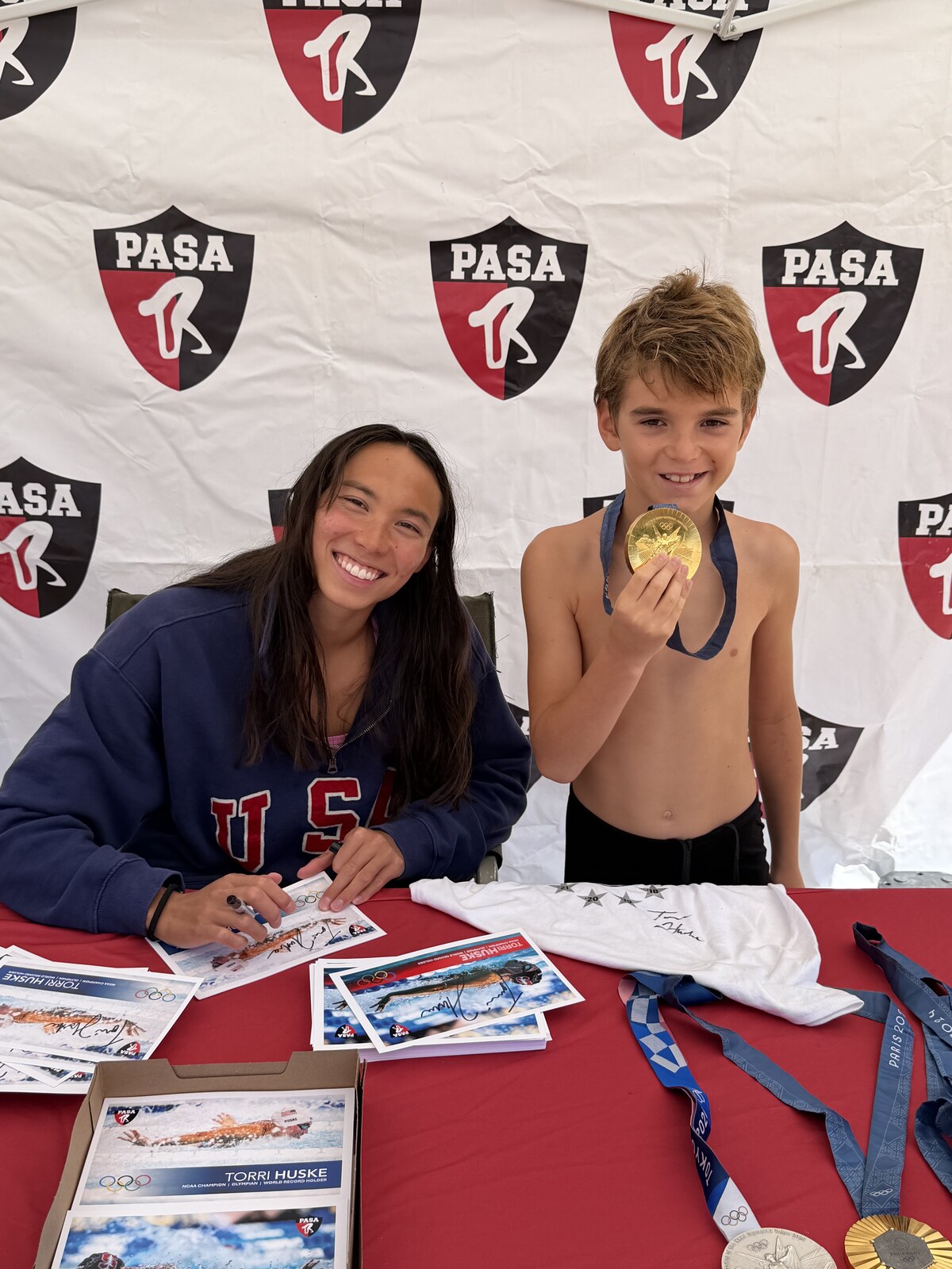 Olympic champion Torri Huske with PASA swimmers at PASA-Rinconada, signing autographs and posing with her Paris 2024 Olympic gold medal