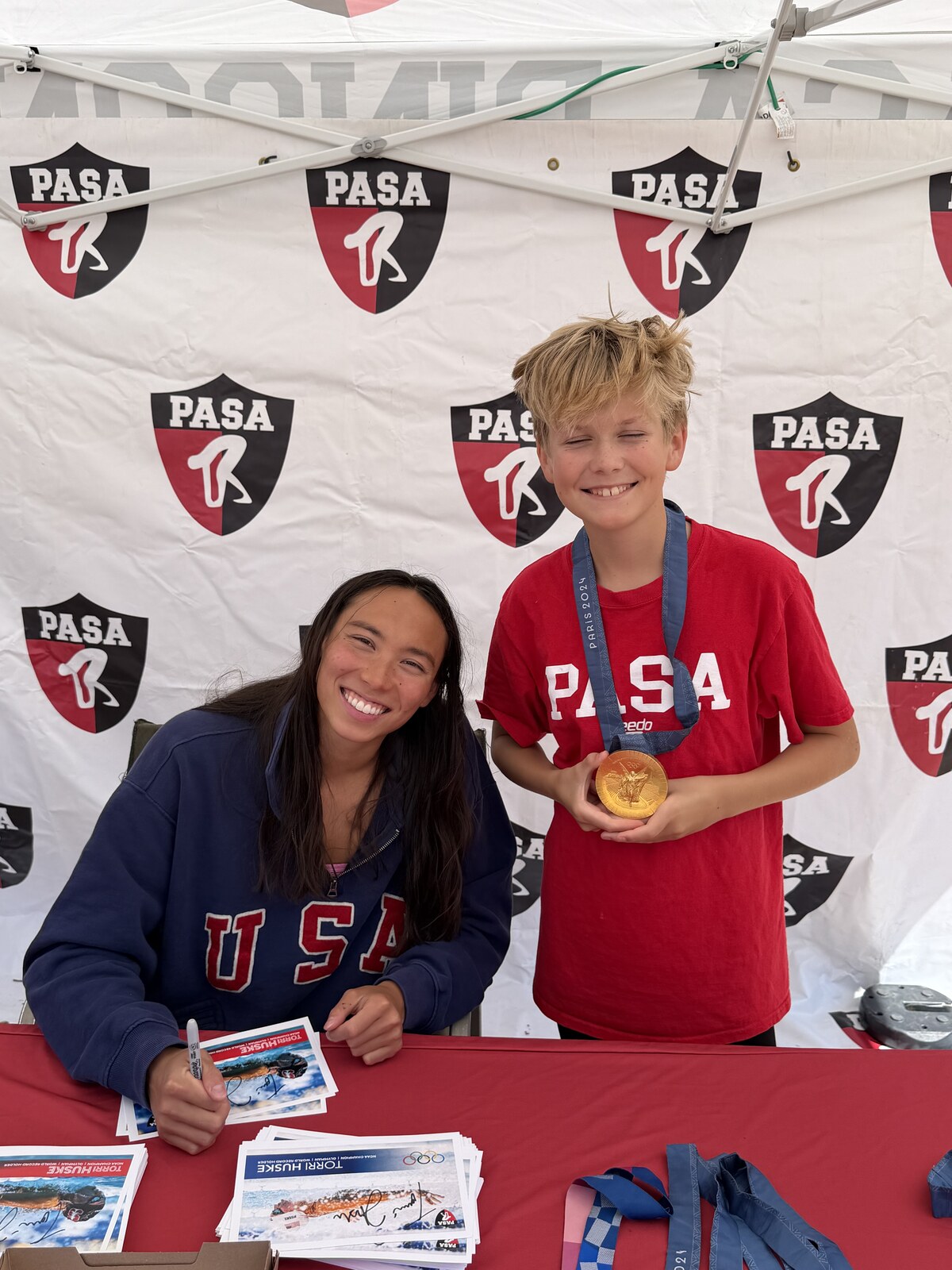 Olympic champion Torri Huske with PASA swimmers at PASA-Rinconada, signing autographs and posing with her Paris 2024 Olympic gold medal