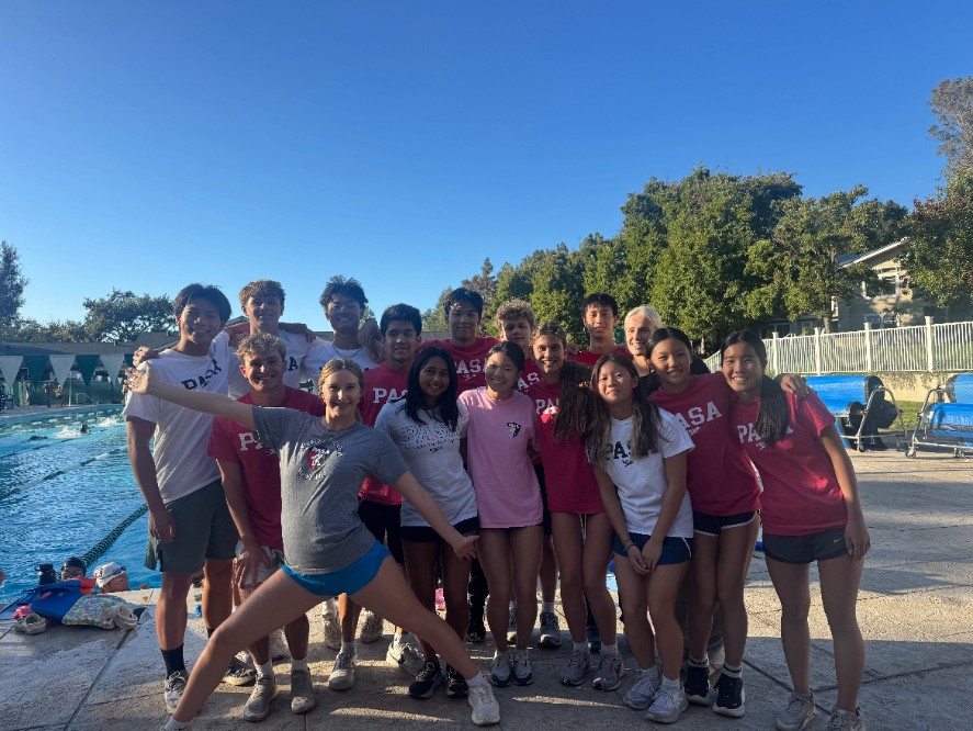 PASA-DKS swimmers and coaches in red team shirts gathered at the pool for PASA Pride Day