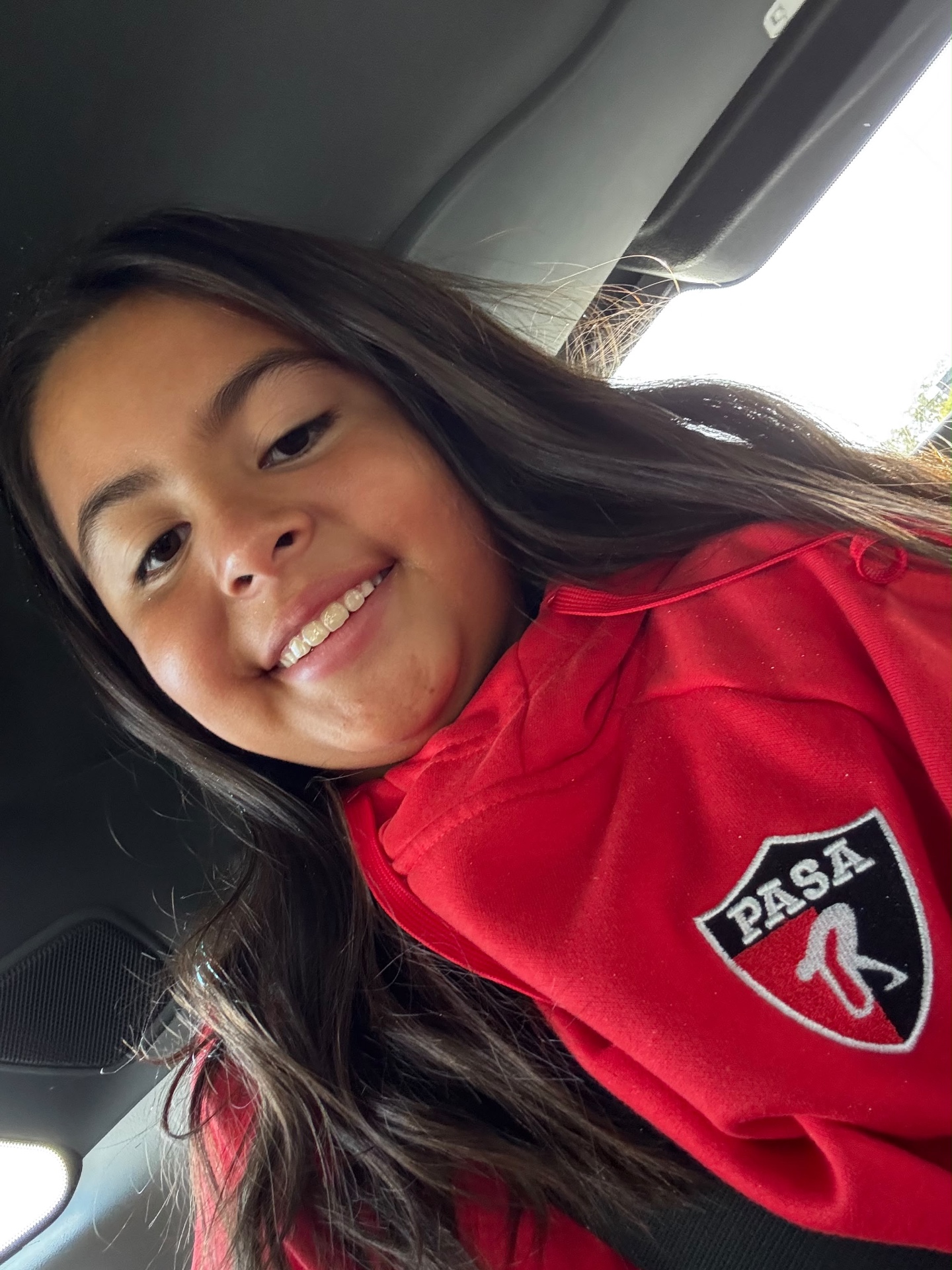 Close-up of the PASA shield patch on a red team jacket