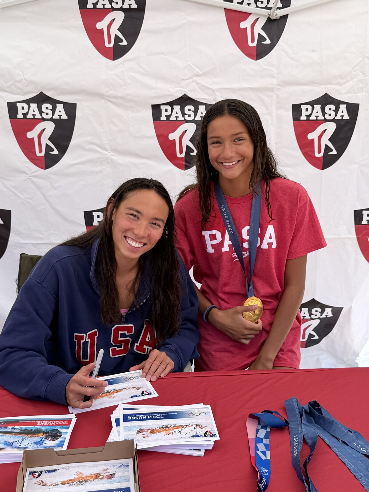 Olympic champion Torri Huske with PASA swimmers at PASA-Rinconada, signing autographs and posing with her Paris 2024 Olympic gold medal