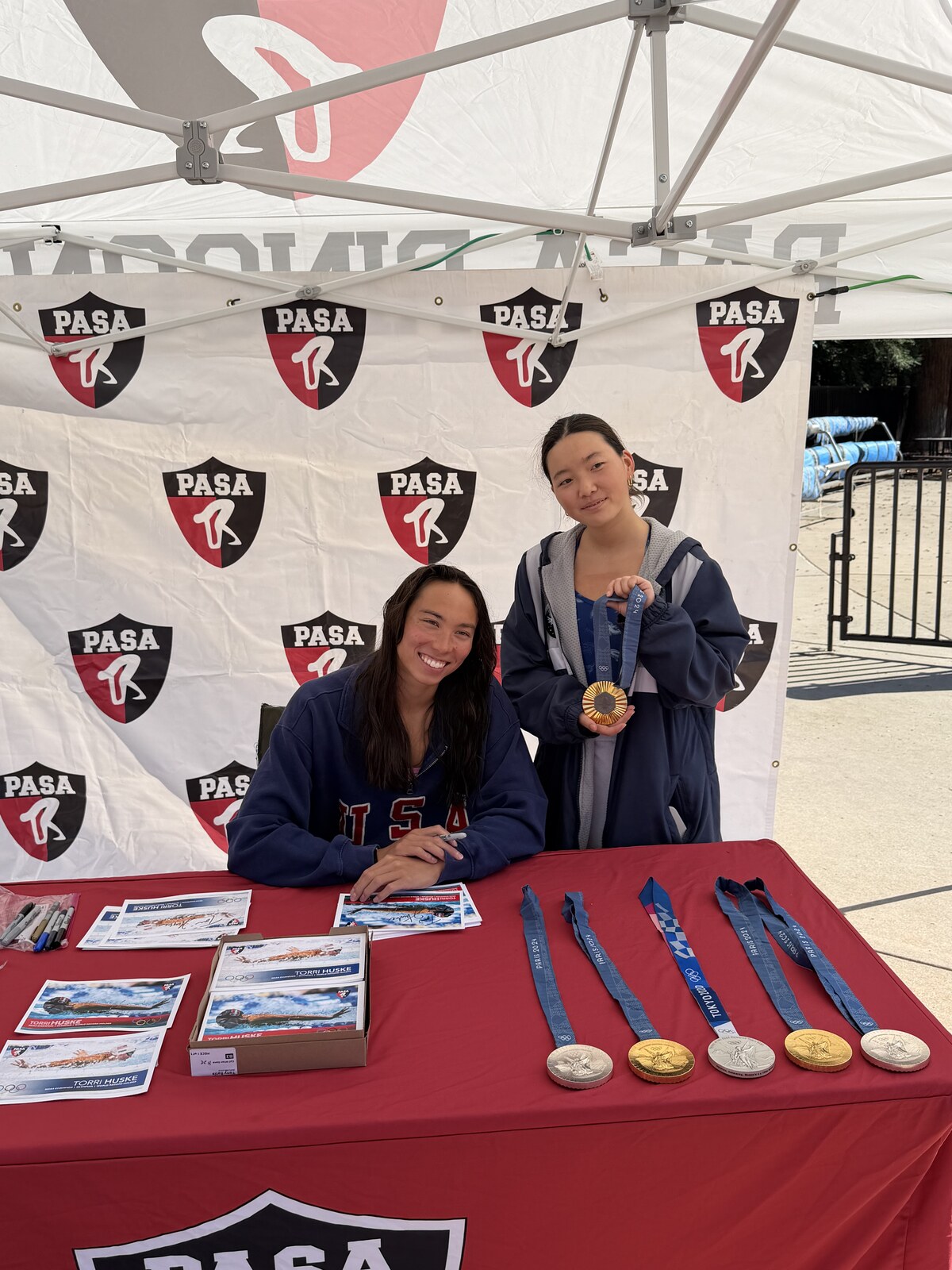 Olympic champion Torri Huske with PASA swimmers at PASA-Rinconada, signing autographs and posing with her Paris 2024 Olympic gold medal