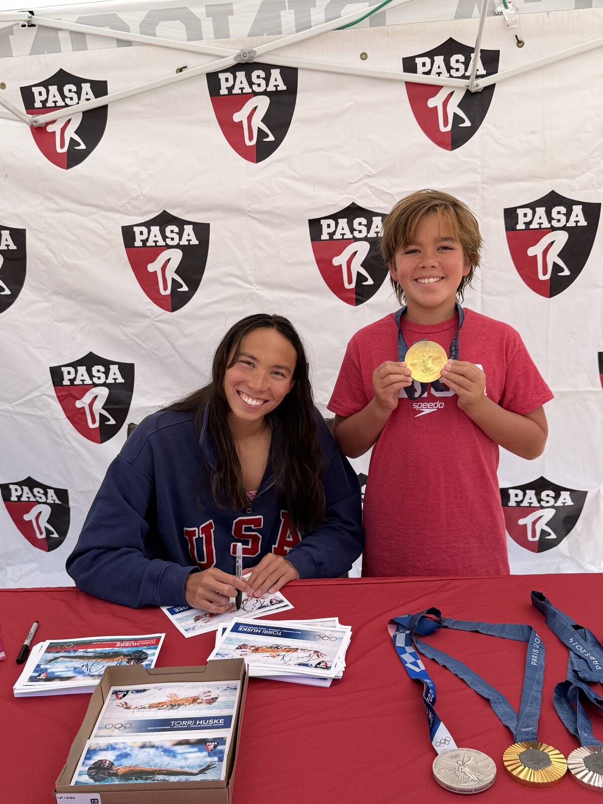 Olympic champion Torri Huske with PASA swimmers at PASA-Rinconada, signing autographs and posing with her Paris 2024 Olympic gold medal
