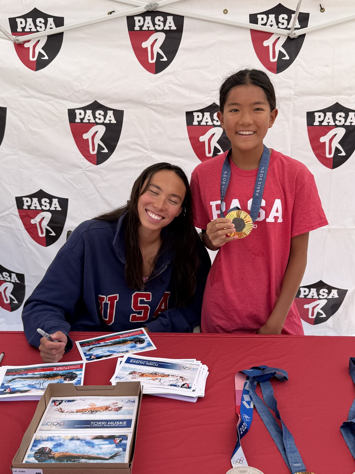 Olympic champion Torri Huske with PASA swimmers at PASA-Rinconada, signing autographs and posing with her Paris 2024 Olympic gold medal
