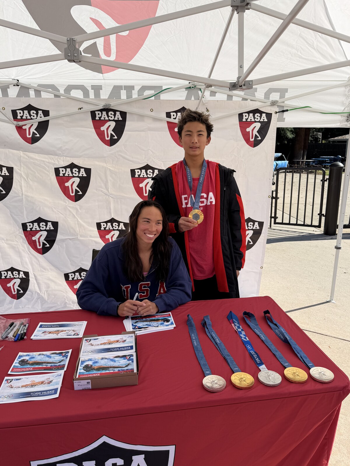 Olympic champion Torri Huske with PASA swimmers at PASA-Rinconada, signing autographs and posing with her Paris 2024 Olympic gold medal