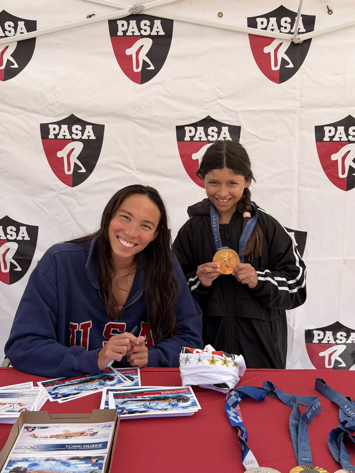Olympic champion Torri Huske with PASA swimmers at PASA-Rinconada, signing autographs and posing with her Paris 2024 Olympic gold medal