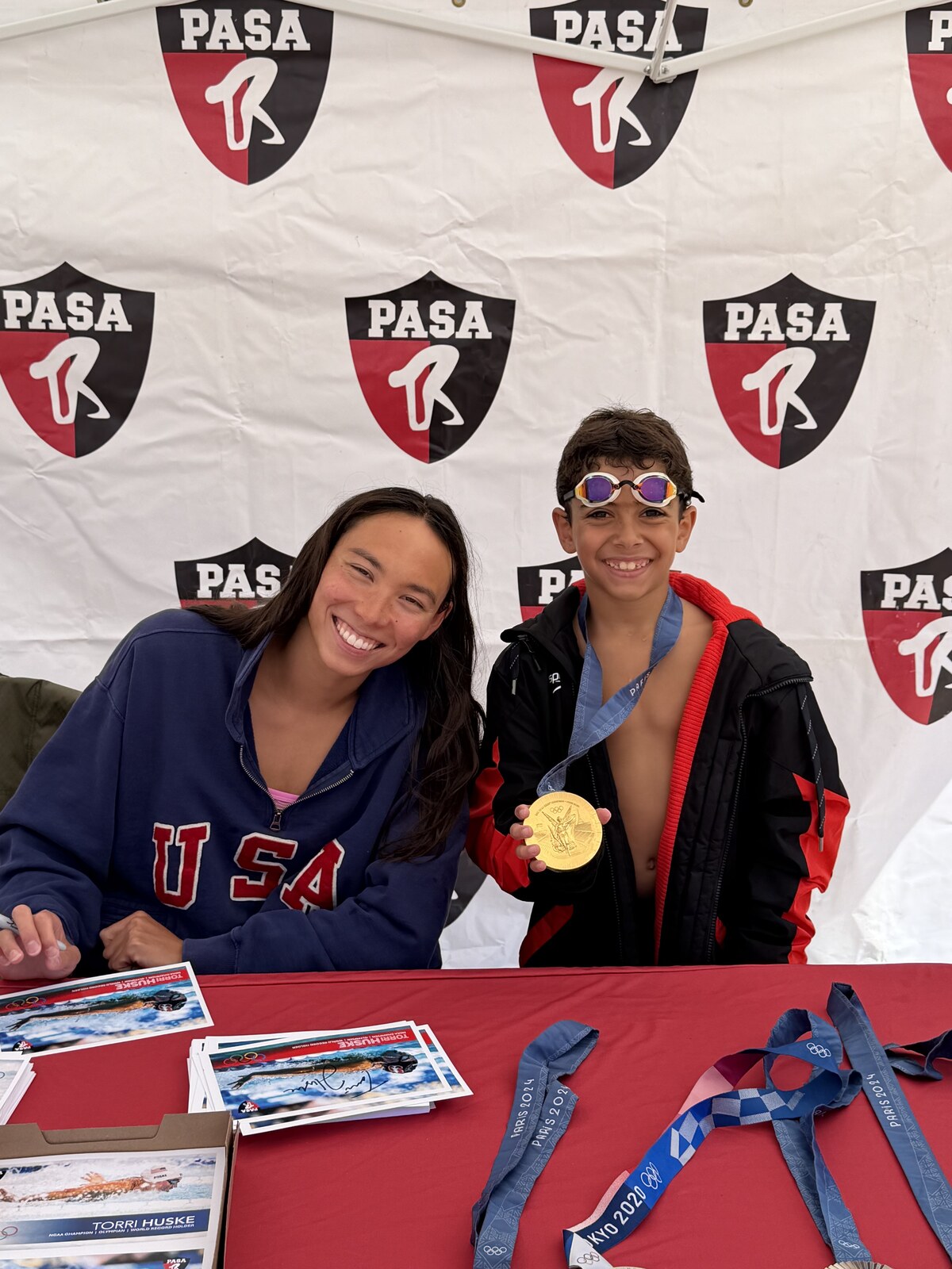 Olympic champion Torri Huske with PASA swimmers at PASA-Rinconada, signing autographs and posing with her Paris 2024 Olympic gold medal