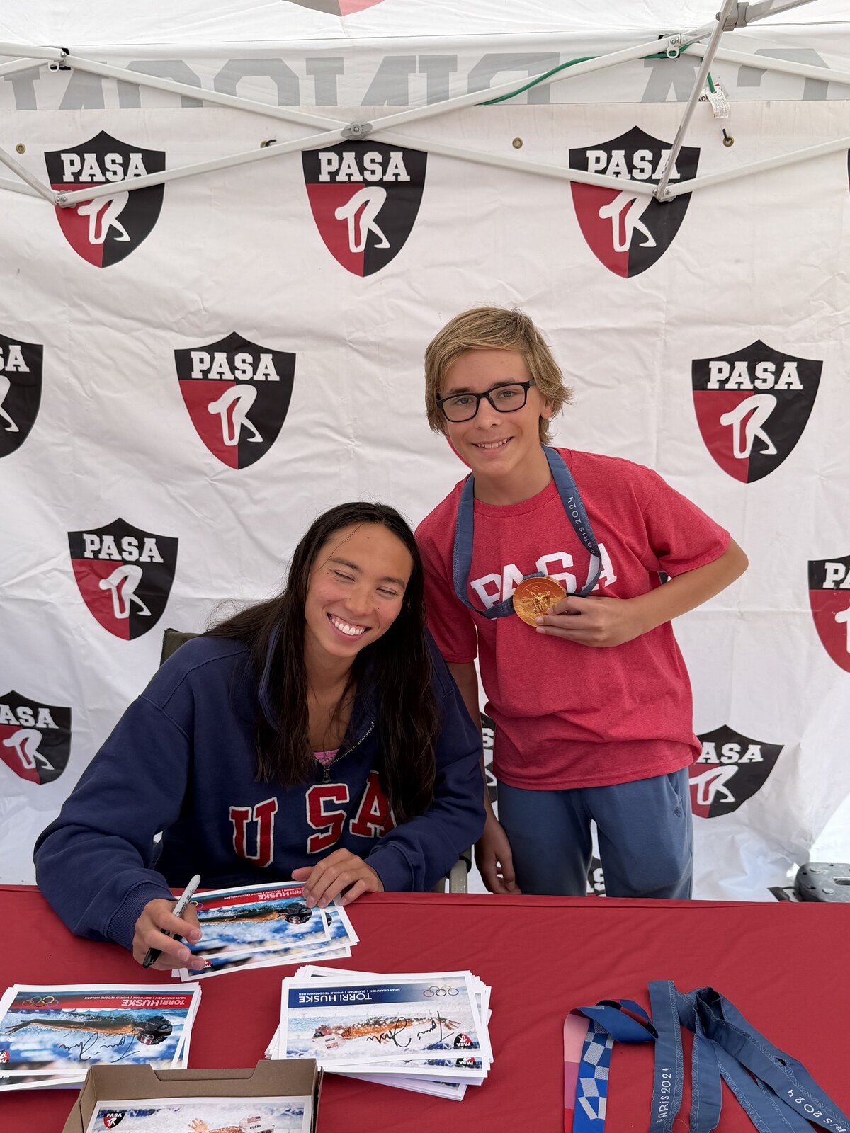 Olympic champion Torri Huske with PASA swimmers at PASA-Rinconada, signing autographs and posing with her Paris 2024 Olympic gold medal