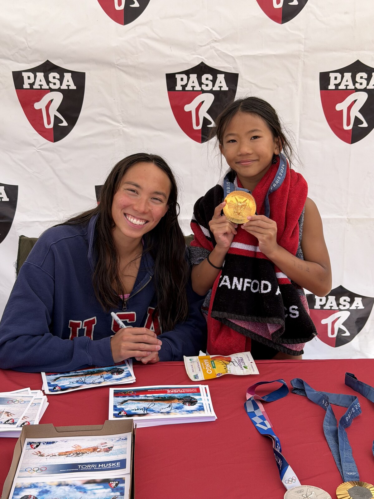Olympic champion Torri Huske with PASA swimmers at PASA-Rinconada, signing autographs and posing with her Paris 2024 Olympic gold medal