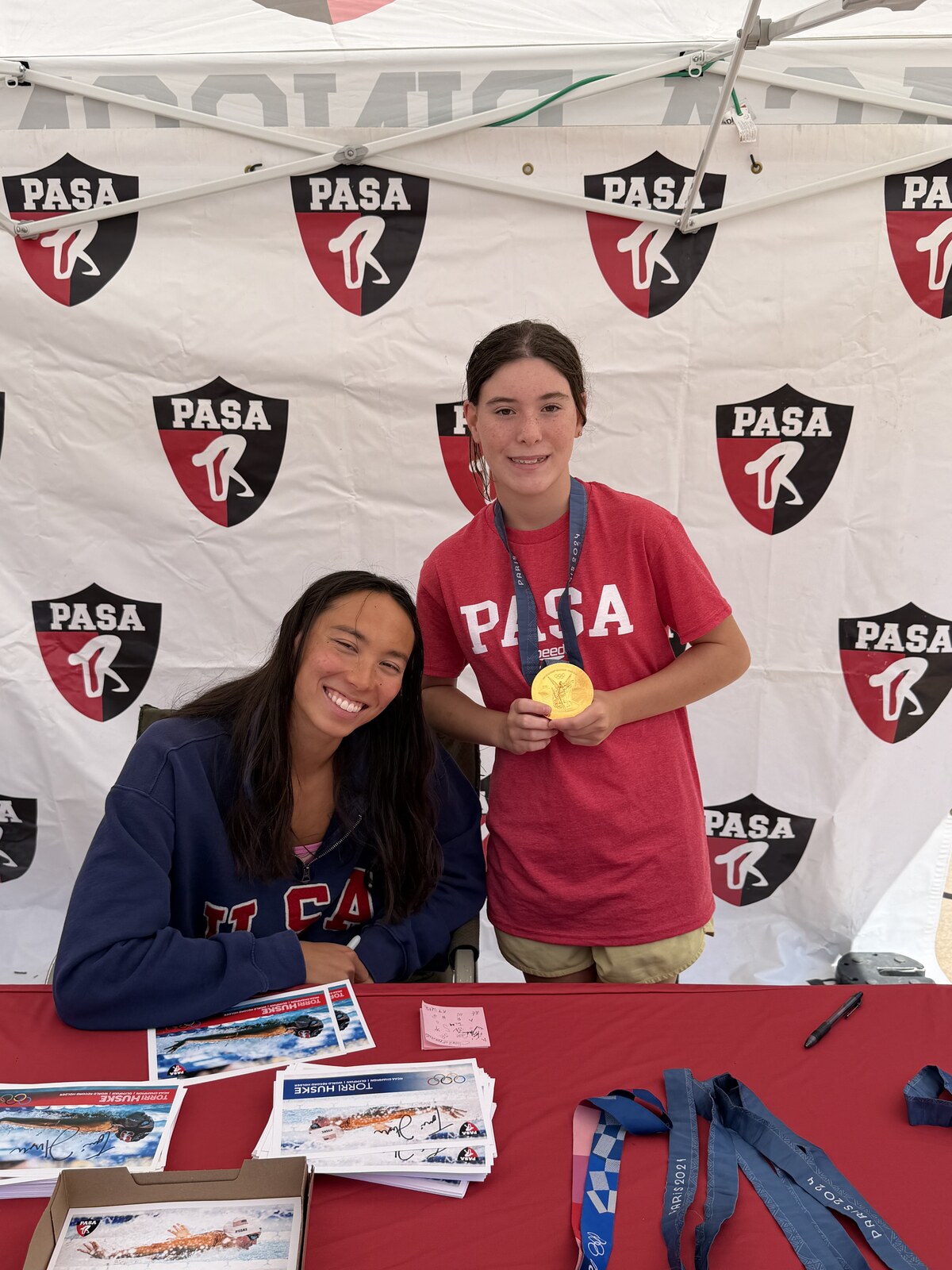 Olympic champion Torri Huske with PASA swimmers at PASA-Rinconada, signing autographs and posing with her Paris 2024 Olympic gold medal