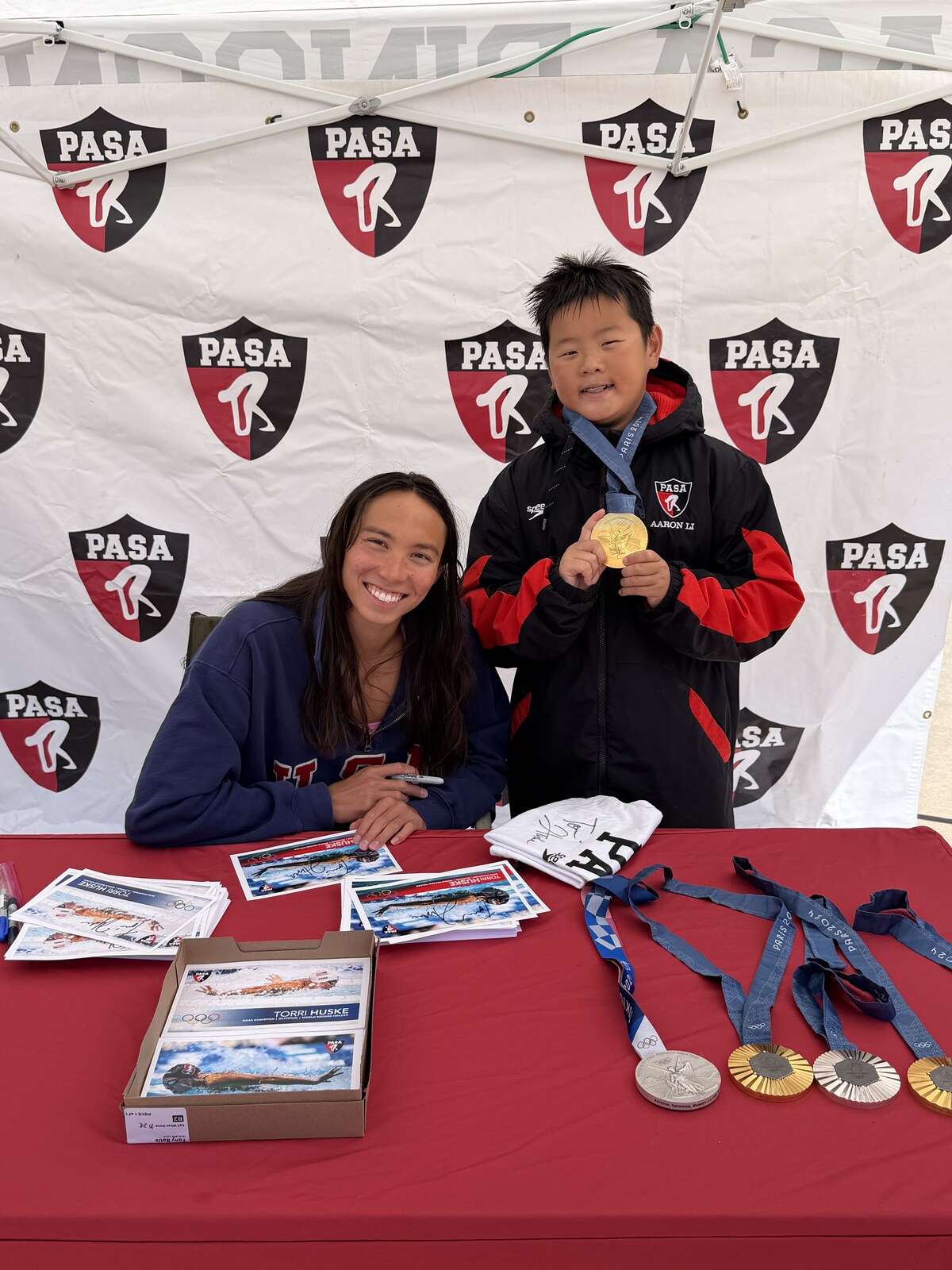 Olympic champion Torri Huske with PASA swimmers at PASA-Rinconada, signing autographs and posing with her Paris 2024 Olympic gold medal