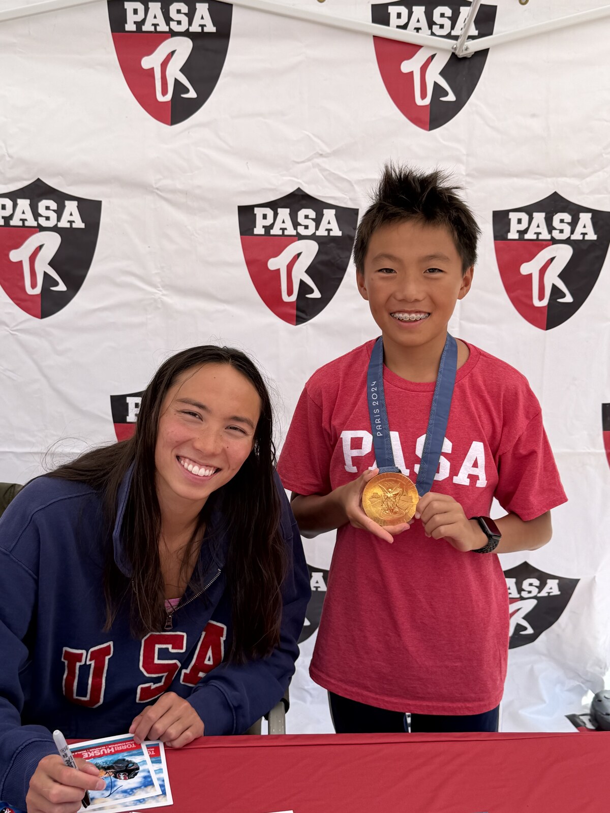 Olympic champion Torri Huske with PASA swimmers at PASA-Rinconada, signing autographs and posing with her Paris 2024 Olympic gold medal