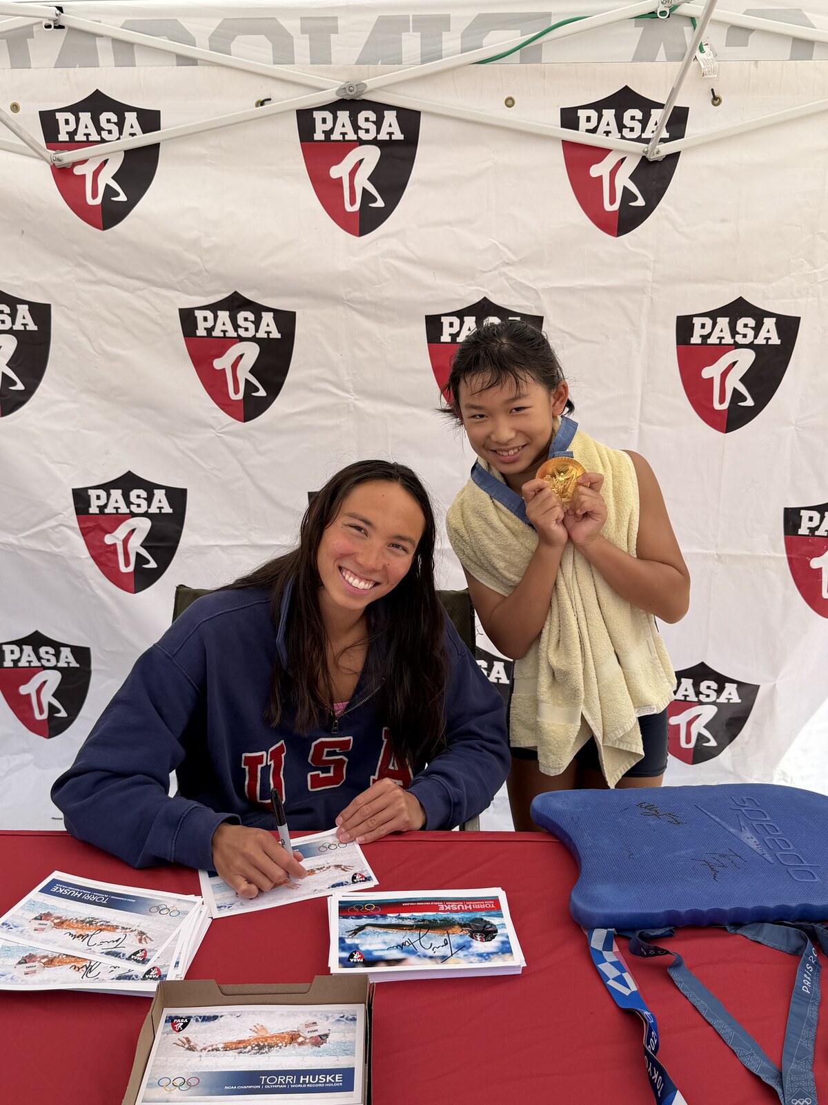 Olympic champion Torri Huske with PASA swimmers at PASA-Rinconada, signing autographs and posing with her Paris 2024 Olympic gold medal