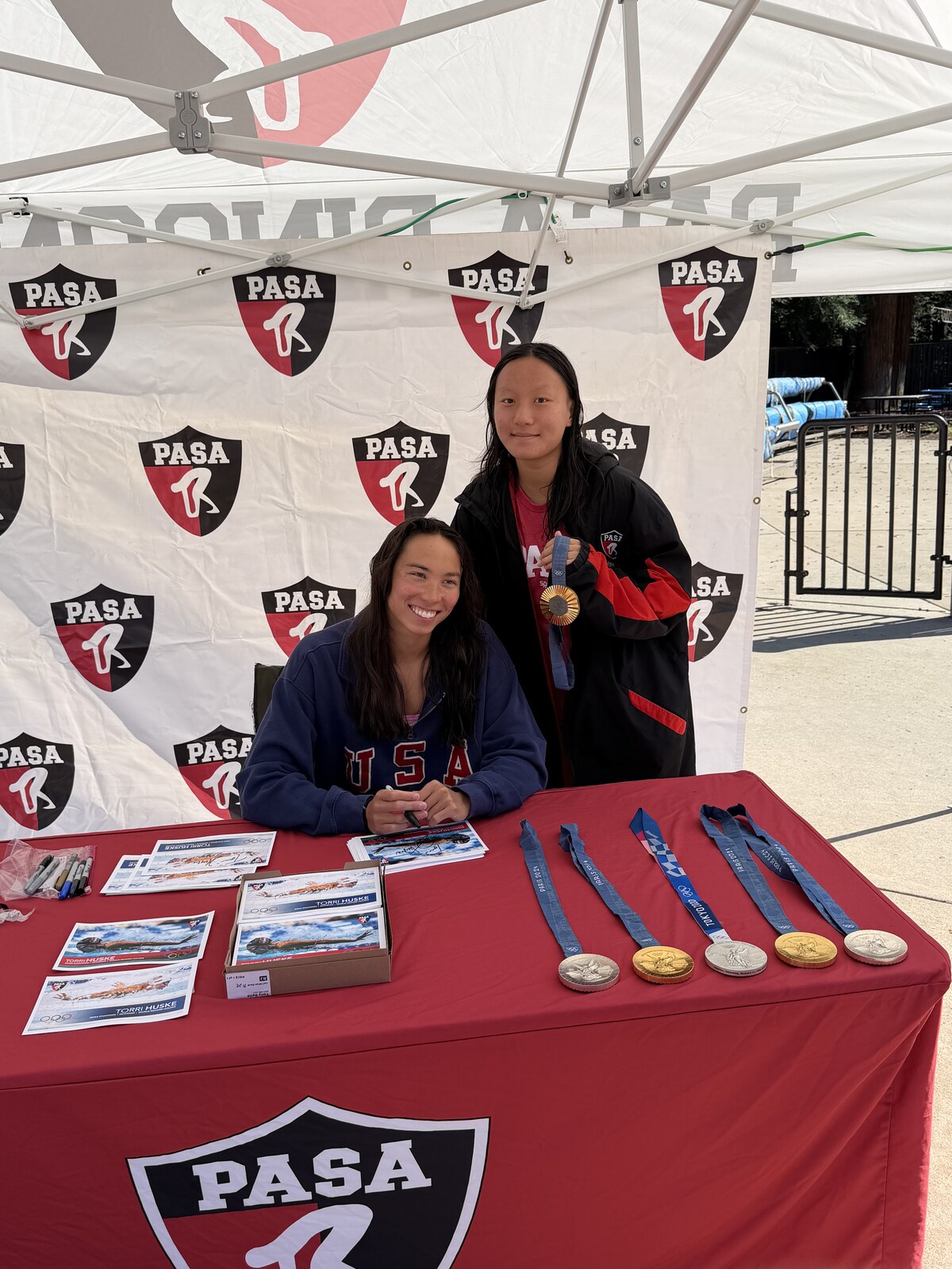 Olympic champion Torri Huske with PASA swimmers at PASA-Rinconada, signing autographs and posing with her Paris 2024 Olympic gold medal