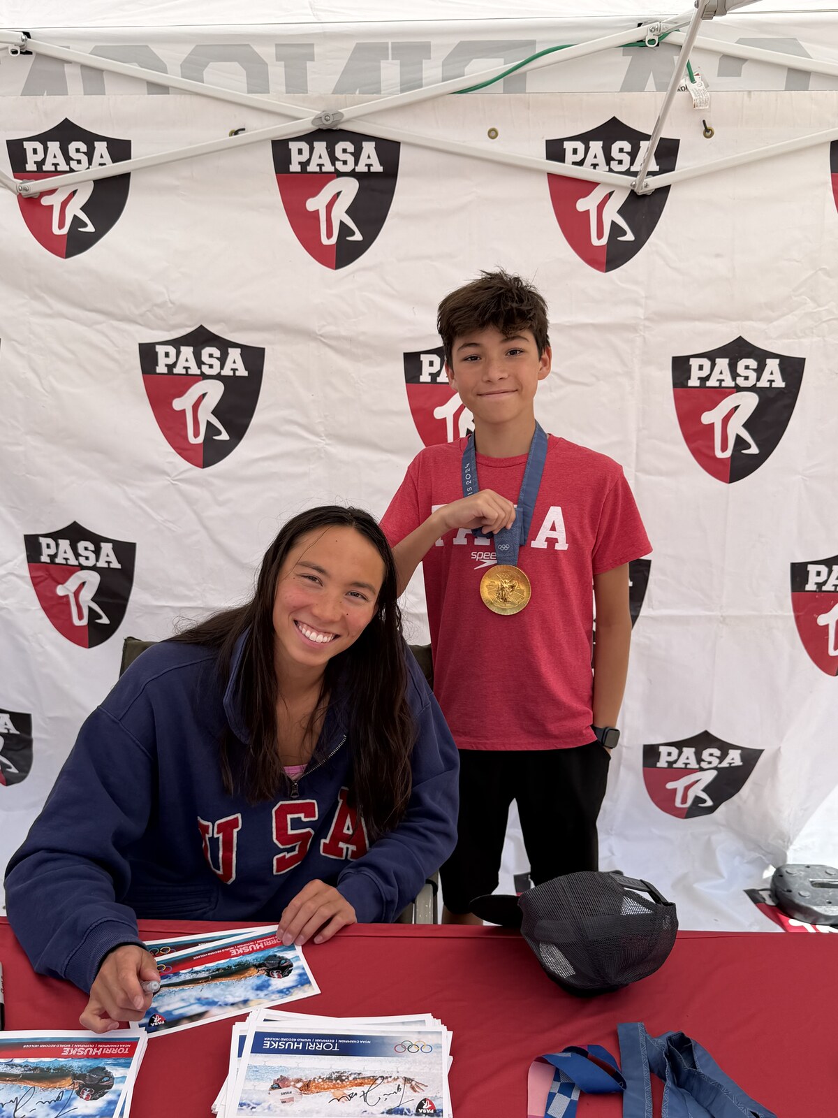 Olympic champion Torri Huske with PASA swimmers at PASA-Rinconada, signing autographs and posing with her Paris 2024 Olympic gold medal