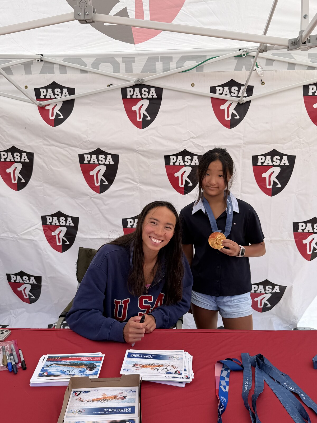 Olympic champion Torri Huske with PASA swimmers at PASA-Rinconada, signing autographs and posing with her Paris 2024 Olympic gold medal