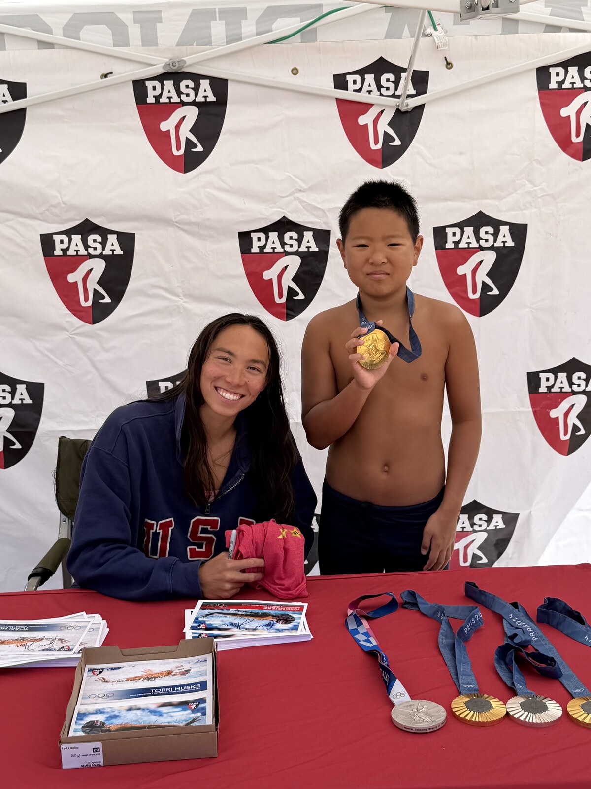Olympic champion Torri Huske with PASA swimmers at PASA-Rinconada, signing autographs and posing with her Paris 2024 Olympic gold medal