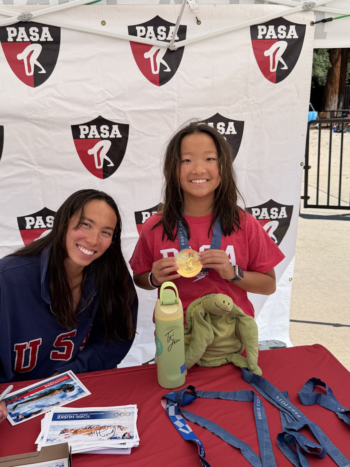 Olympic champion Torri Huske with PASA swimmers at PASA-Rinconada, signing autographs and posing with her Paris 2024 Olympic gold medal