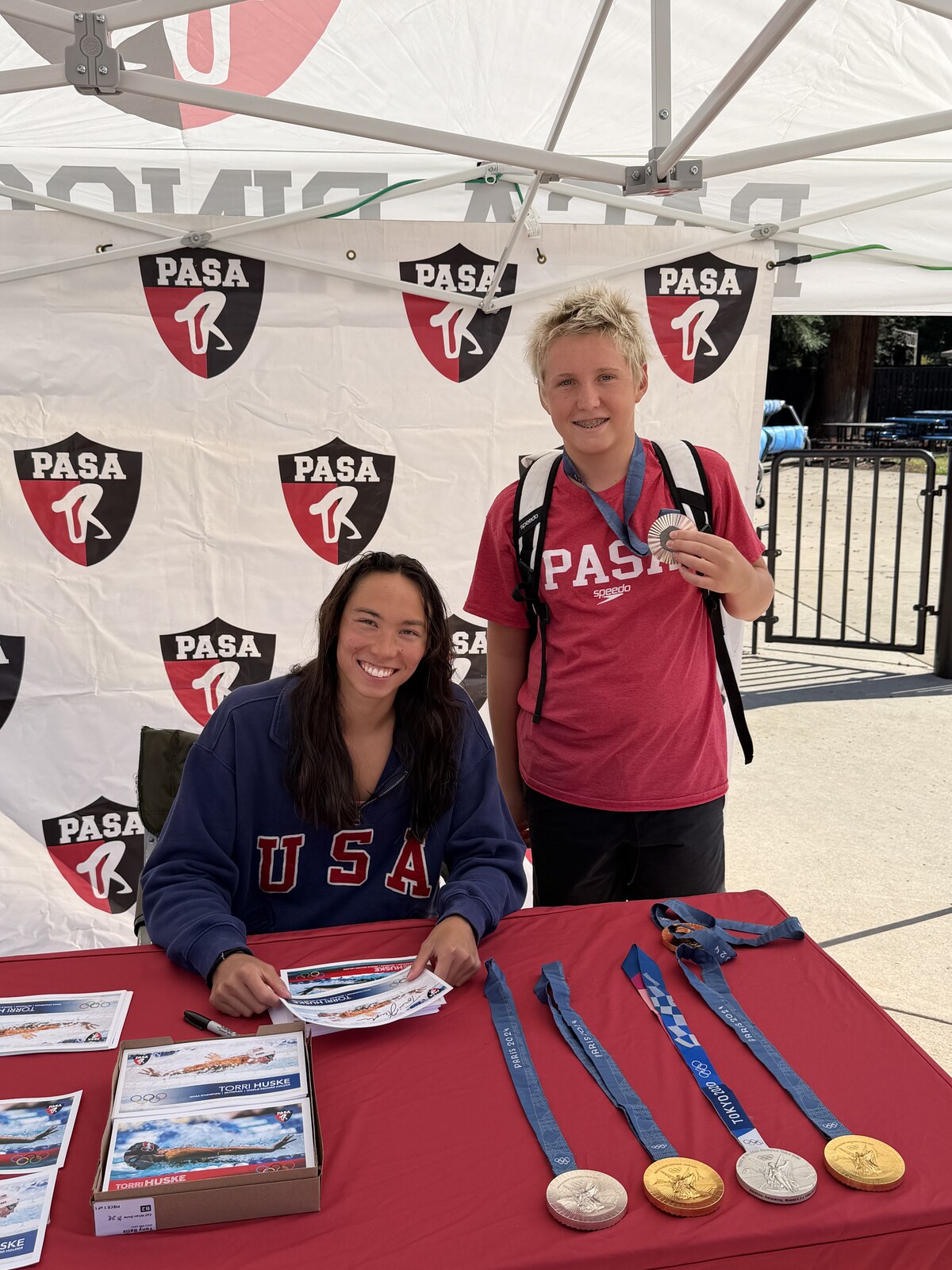 Olympic champion Torri Huske with PASA swimmers at PASA-Rinconada, signing autographs and posing with her Paris 2024 Olympic gold medal