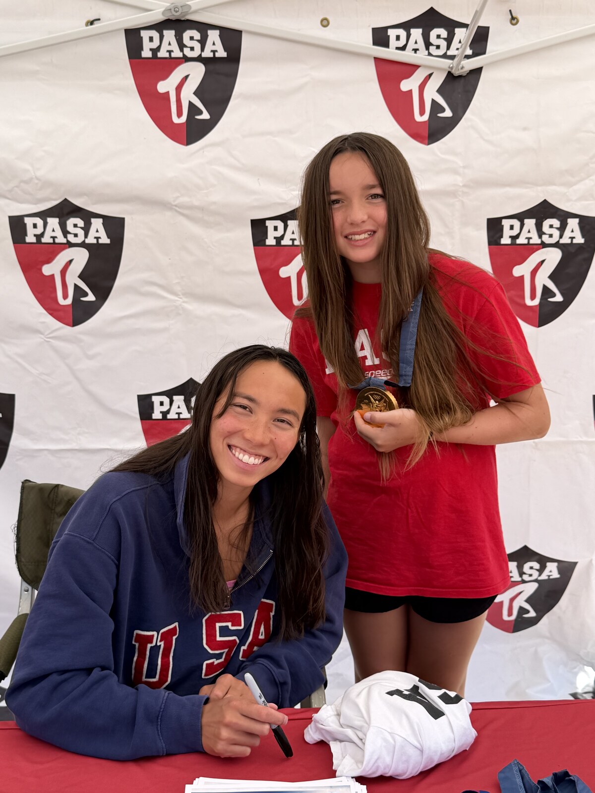 Olympic champion Torri Huske with PASA swimmers at PASA-Rinconada, signing autographs and posing with her Paris 2024 Olympic gold medal