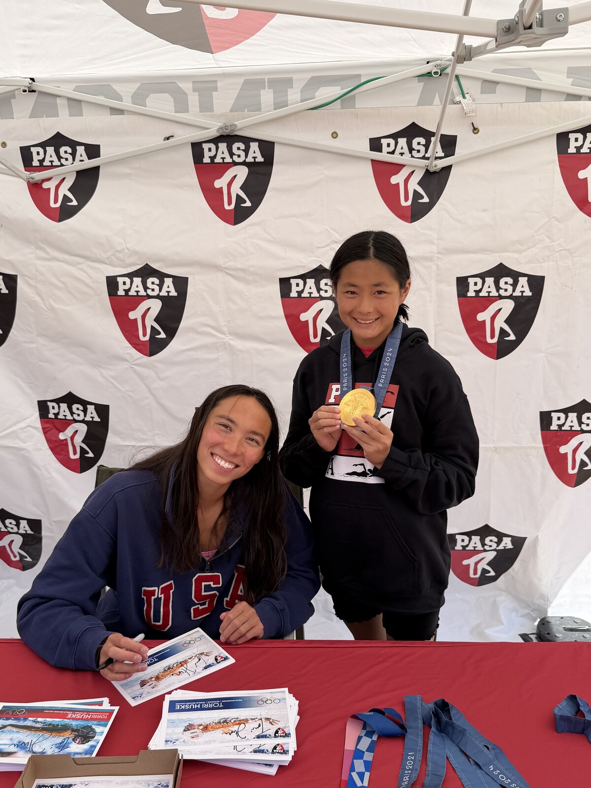 Olympic champion Torri Huske with PASA swimmers at PASA-Rinconada, signing autographs and posing with her Paris 2024 Olympic gold medal