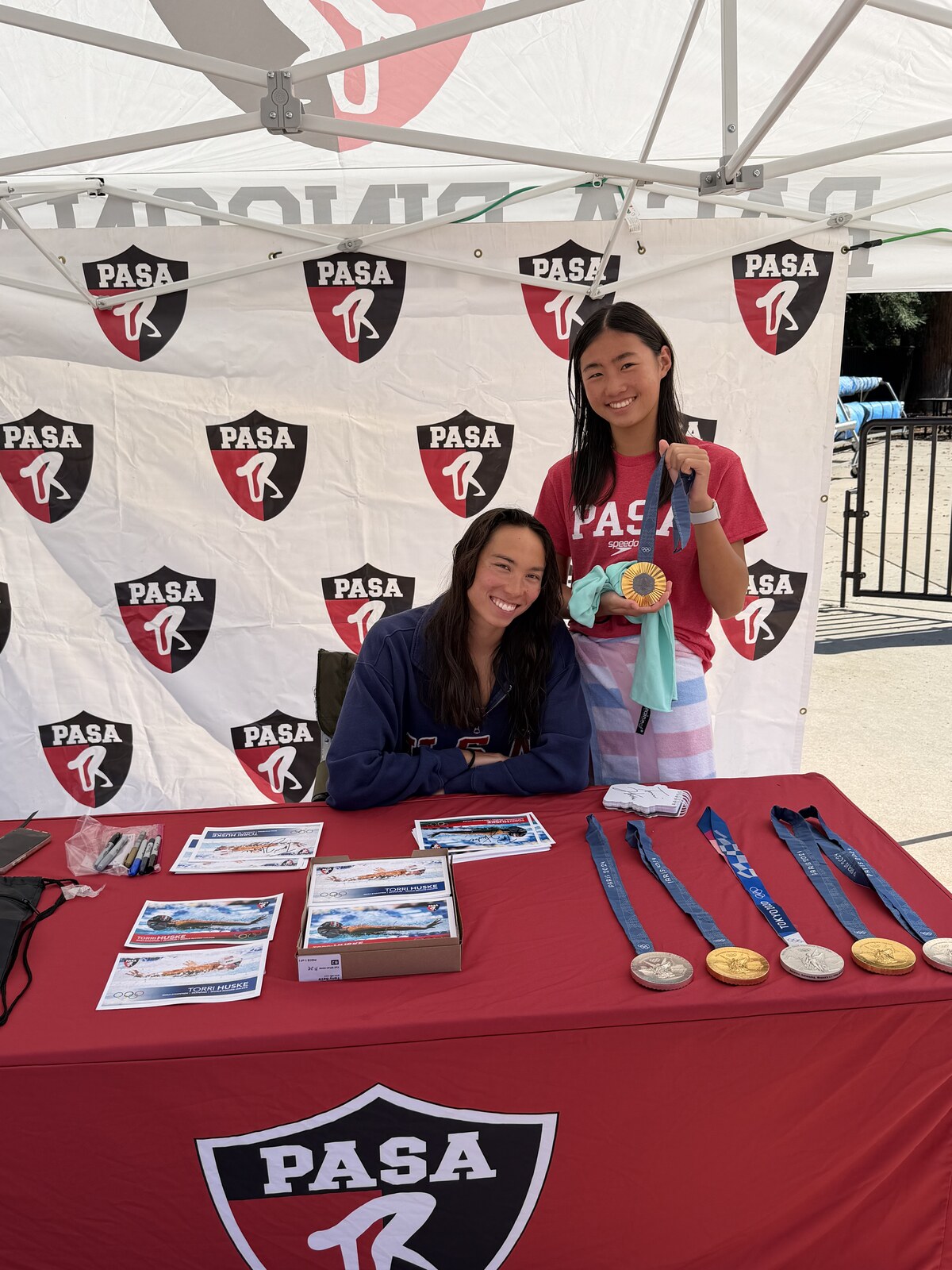 Olympic champion Torri Huske with PASA swimmers at PASA-Rinconada, signing autographs and posing with her Paris 2024 Olympic gold medal