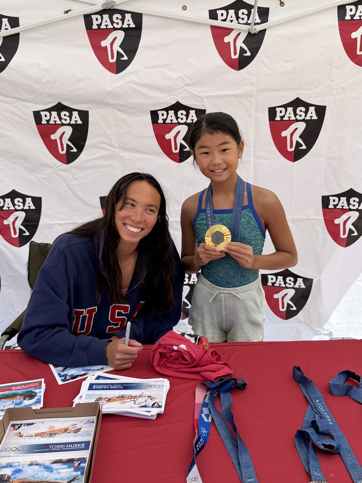 Olympic champion Torri Huske with PASA swimmers at PASA-Rinconada, signing autographs and posing with her Paris 2024 Olympic gold medal
